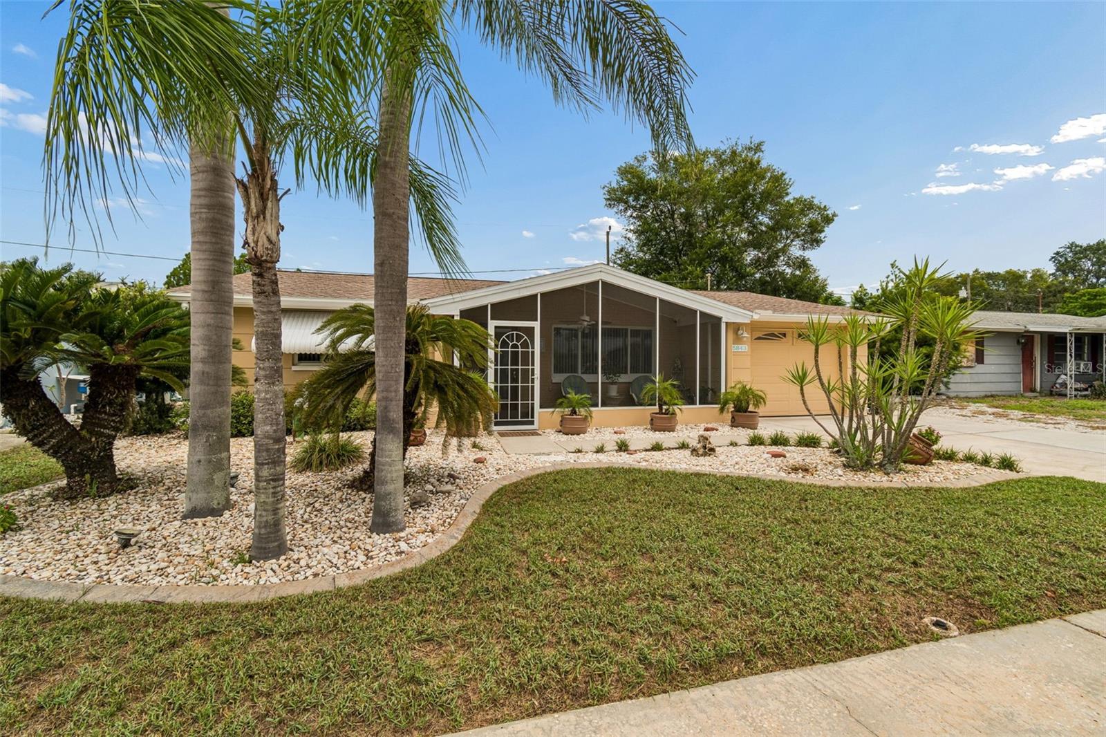 Welcome to your own private slice of the Florida Keys! It is clear this home has been METICULOUSLY maintained & upgraded, w/ pride of ownership! Featuring a 2020 ROOF, HURRICANE-impact WINDOWS & DOORS (& hurricane film), hurricane SHUTTERS & GARAGE door brace, whole-house GENERATOR w/ integrated transfer switch, upgraded IRRIGATION system, & HARDWIRED 14-camera security system.

Step through the screened front porch & beautiful glass front door, where natural sunlight fills the inviting living room. The open layout showcases ceramic tile flooring throughout the main living areas, creating a bright & seamless flow into the dining room & beautifully updated kitchen. The kitchen features  granite countertops, a charming breakfast bar, appliances including a built-in oven, cooktop, microwave, side-by-side refrigerator, a large deep stainless sink w/garbage disposal, & TWO convenient pass-through windows.

The TRUE CENTERPIECE of this home is the incredible climate-controlled FLORIDA ROOM, designed for year-round enjoyment. Equipped w/ a mini-split AC system, wood-look ceramic tile flooring, built-in bar, storage area, & 28 FEET of sliding glass doors that fully open to the pool area! This space is large enough for a pool table, & game room.

The spacious primary suite offers a peaceful retreat w/ wood-look tile flooring, abundant natural light, & a private en-suite office that could easily serve as a third bedroom thanks to its existing closet. The updated primary bathroom features granite countertops, a large mirror, & a walk-in shower. The second bedroom is equally impressive, comfortably accommodating a king-size bedroom set while offering its own walk-in closet & private en-suite bathroom. The guest bath has an oversized vanity, extra-large sink, & elegant glass shower doors.

STEP OUTSIDE & PREPARE TO FALL IN LOVE! The backyard is nothing short of breathtaking, transporting you straight to the Florida Keys w/ its lush tropical landscaping & resort-like atmosphere w/ 30 LED lights to illuminate the backyard at night! The sparkling 6,700-gallon fiberglass SALTWATER POOL is highlighted by beautiful tile featuring a dolphin accent, a VARIABLE-SPEED pool pump (2019), & new (paid off) SOLAR POOL dedicated heating panels (THE HELIOCOL TYPE—for hurricanes), allowing you to enjoy the pool nearly year-round w/ incredible efficiency. The spacious FLORIDA ROOM features new tile flooring, a TV hookup for outdoor entertainment, & a SPEAKER system throughout both the house & pool area, creating the perfect setting for unforgettable gatherings.

Storage is abundant, w/ 5 dedicated sheds housing the WHOLE-HOUSE GENERATOR & supplies, pool equipment & chemicals, beach chairs (which convey), lawn equipment, & additional tools. The low-maintenance backyard is designed w/ decorative rock & minimal grass, allowing you to spend more time enjoying your home instead of maintaining it. Even better, the 60" stainless grill, pool furniture, decorative planters, & potted plants all convey, making this truly move-in ready.

Additional upgrades include A NEW WHOLE HOUSE WATER SOFTNER FILTRATION system, all A/C ducts professionally cleaned & recoated, new recessed lighting, a UPGRADED DIGITAL WATER HEATER, hurricane-impact FRENCH DOORS, new GARAGE DOOR OPENER w/ upgraded springs, rollers, & belt-drive system, & countless additional improvements that make this property stand apart from the rest. Fully fenced-in backyard w/ separate dog area.