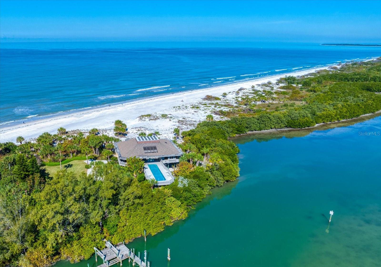 An opportunity of this caliber rarely presents itself on the west coast of Florida, 1198 Mandalay Point represents extraordinary value for one of the state's most exclusive waterfront properties. Set on 42.57 acres at the secluded northern tip of Clearwater Beach, this remarkable beach to bay property is the last and only private residence of its kind. Bordered on the north by the untouched beauty of Caladesi Island State Park and accessible by a private road, the estate offers unmatched tranquility with miles of pristine beach. For the yachting enthusiasts, a rare deep-water dock accommodates vessels up to 80 feet, providing direct access to the Intracoastal Waterway and the Gulf of America for effortless cruising, fishing and island hopping. This is more than a home - it is a private sanctuary, a lifestyle investment, and a generational legacy. With its protected setting, private entrance, and rare beach-to-bay frontage, 1198 Mandalay Point stands alone as the crown jewel of Clearwater Beach real estate.
The 3,434 square foot residence is elevated 20 feet above sea level to showcase panoramic Gulf to Bay views. Inside, soaring 30 plus foot ceilings crown an atrium with a heated lap pool, overlooking the lush preserves of the south end of Caladesi Island, Malone and Moonshine Islands. Each room frames views of sunrises, sunsets and importantly - 360 degrees of palm trees, sandy beaches, the gulf and the bay.
Whether entertaining guests or enjoying quiet moments, this home provides an unparalleled living experience. From its tranquil setting and proximity to Tampa International Airport to its world-class dockage and breathtaking natural beauty, 1198 Mandalay Point offers everything you need to enjoy the best of Florida living. An exceptional offering.