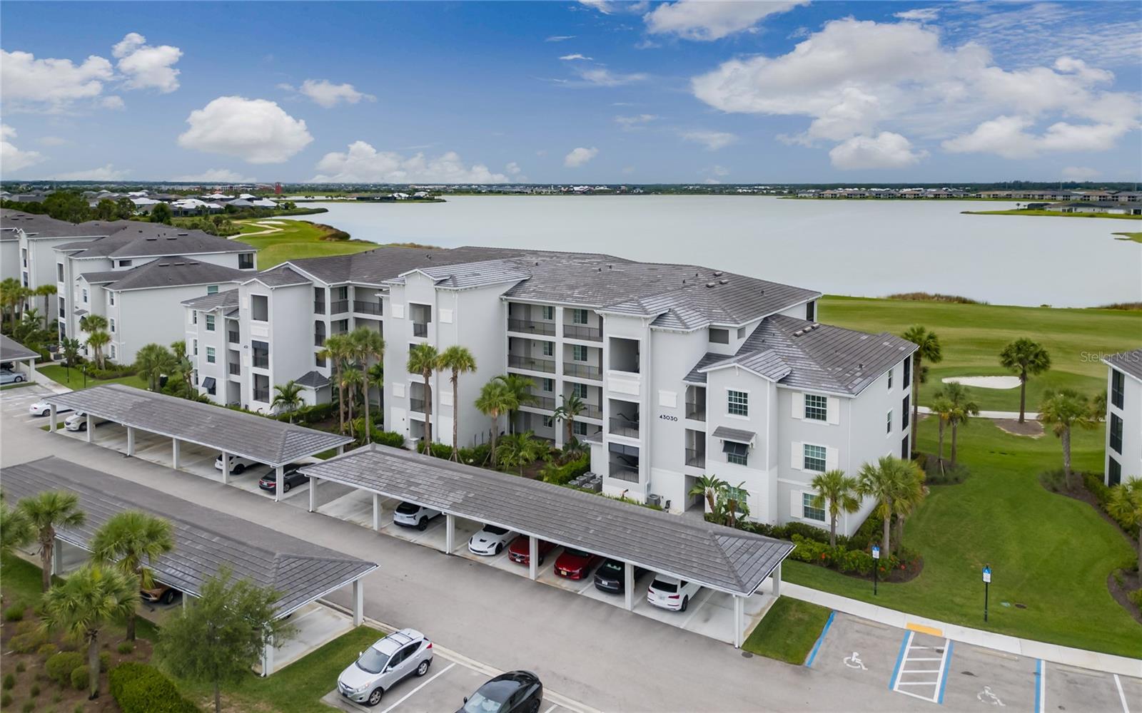 Experience the ultimate Southwest Florida lifestyle from this lakefront 3RD FLOOR condominium in Babcock National, where BUNDLED GOLF MEMBERSHIP is included on a golf course crafted by renowned golf course architect Gordon Lewis. Designed for both comfort and style, this TURNKEY, VERY LIGHTLY LIVED IN, residence showcases an open-concept layout with elegant finishes throughout, including tile flooring, crown molding and volume ceilings that enhance the bright, airy feel of the home. The gourmet kitchen is thoughtfully appointed with granite countertops, stainless steel appliances, recessed lighting, a spacious center island with seating and a pantry for additional storage. The spacious primary suite offers dual walk-in closets and tiled walk-in shower. Step outside to the screened lanai and enjoy peaceful mornings overlooking Lake Babcock and manicured fairways. Residents of Babcock National enjoy access to an impressive collection of completed amenities, including a resort-style pool with lap lanes and The WATERSHED GRILL a members only pool side tiki bar, a state-of-the-art fitness center with saunas and locker rooms, tennis, pickleball and bocce courts, plus the newly opened clubhouse restaurant THE ENCLAVE for upscale dining and social gatherings. Located within the award-winning community of Babcock Ranch, you’re just moments from charming restaurants, coffee shops, live entertainment, shopping, food trucks and weekly community events. Perfect as a full-time residence, seasonal retreat or investment property, this exceptional home offers luxury, convenience and the added value of bundled golf in one of Southwest Florida’s most sought-after communities.