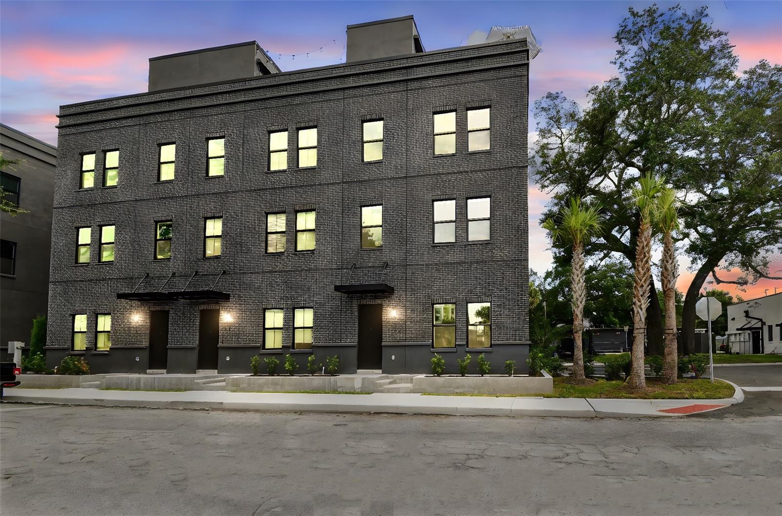Only 5 units remain! Move-in ready units available now. Step into the heartbeat of Tampa’s most electric neighborhood with Canvas City Homes GWX, a limited collection of industrial-chic city homes inspired by the bold spirit of Ybor City. This is where historic brick cigar factories meet modern design, where art, culture, and nightlife collide just outside your door. From the street-level entry to your private rooftop terrace with city skyline views, every detail is designed for life in motion. Inside, 10-foot ceilings, exposed block walls, and bright sunlit spaces create the perfect backdrop for your personal style. The ground floor sets the tone with polished concrete floors and a sleek ensuite bedroom. Upstairs, the massive kitchen island takes center stage, made for dinner parties, cocktails with friends, or Sunday morning brunch. On the top floor, the primary suite delivers main-character energy with double walk-in closets ready for your best fits. Step outside, and you’re minutes from Ybor’s buzzing restaurants, bars, and art studios, or hop on the streetcar to explore Downtown, Channelside, or Sparkman Wharf. With the transformative Gas Worx development rising just steps away, this neighborhood is only getting hotter, and Canvas GWX puts you in the front row. Whether you’re looking for a primary residence or investment property, Canvas GWX puts you ahead of the curve in one of Tampa's fastest-growing neighborhoods. Secure your spot today and call Canvas GWX home in the city’s most vibrant district. Move-in ready homes are available now, with limited-time buyer incentives. Photos are of model unit.