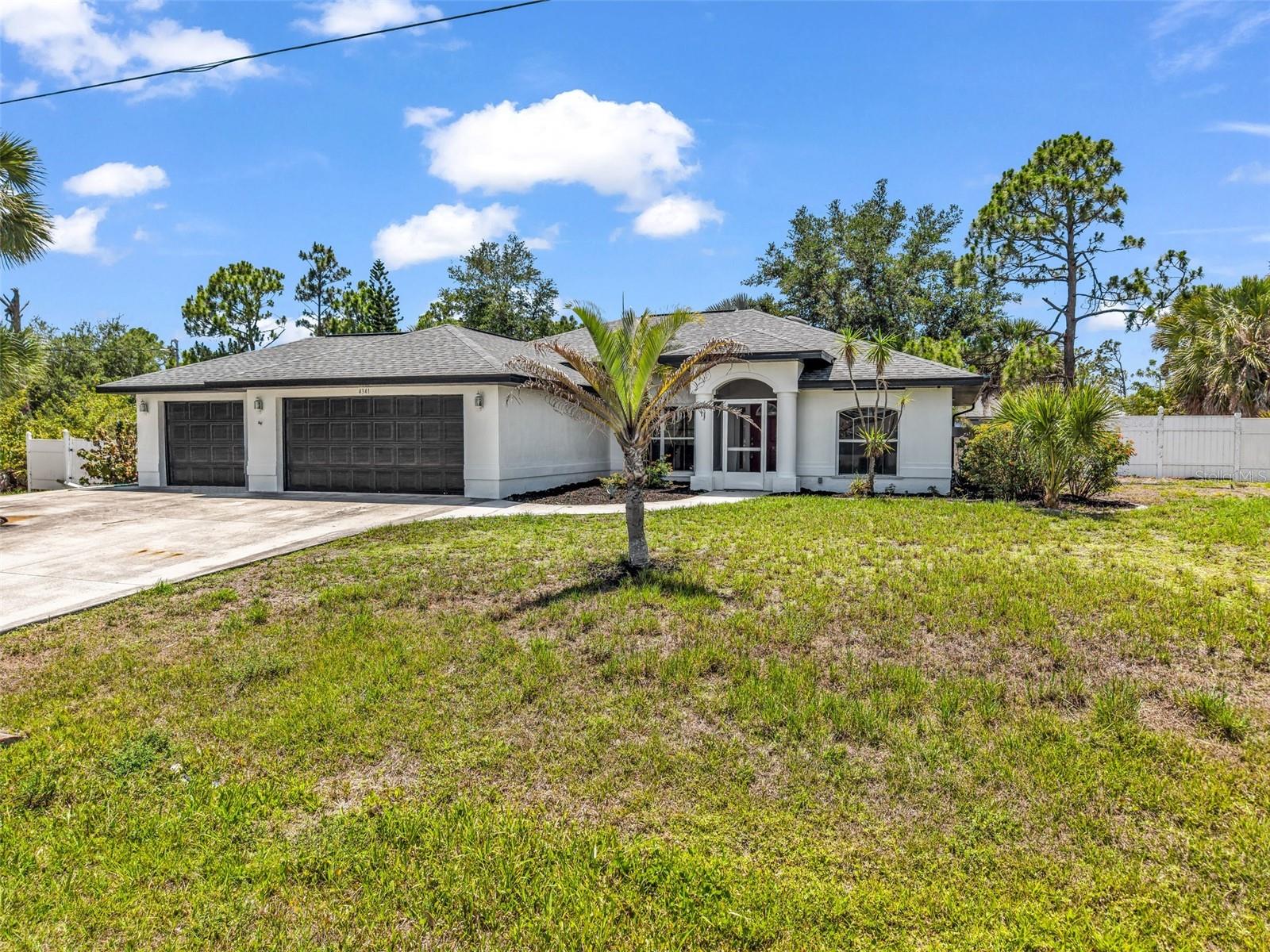 Welcome to Gulf Cove! Situated on a double lot totaling nearly half an acre, this 3-bedroom, 2-bath home offers plenty of space both inside and out. The oversized 3-car garage provides room for vehicles, storage, hobbies, or workshop space.

Inside, you'll find large profile tile flooring throughout and a remodeled kitchen featuring quartz countertops, updated cabinetry, and a modern design that flows into the main living areas. Major improvements include a new roof and new A/C.

Step outside to enjoy the covered rear lanai, offering additional outdoor living space for relaxing or entertaining. The double lot provides extra room for outdoor activities, parking, or future improvements. The property is located in an X flood zone according to current FEMA maps.

This home combines updated interior features, significant lot size, and a functional layout in the Gulf Cove area.
