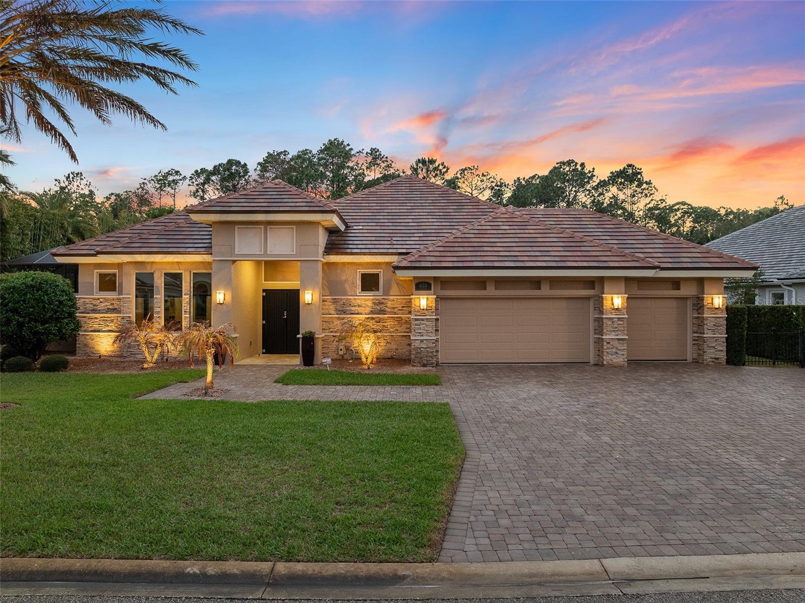Welcome to 410 Wingspan Drive, a custom luxury courtyard estate in the private Woodbridge Estates of Plantation Bay Golf & Country Club. Built by renowned Kargar Construction Group, this energy-efficient home combines craftsmanship, smart home technology and resort-style outdoor living on a private preserve lot. Guests enter through double glass doors with electronic locks and wireless doorbell into a grand foyer with polished porcelain floors and crystal chandelier. The family room, the heart of the home, features porcelain floors, a floating tray ceiling with LED accent lighting, and custom built-in cabinetry with floating shelves. Four 10-foot sliding glass doors open to the lanai, creating seamless indoor-outdoor living. The chef's kitchen offers Cambria quartz countertops, mosaic tile backsplash, all-wood cabinetry with soft-close drawers, and an elevated island with breakfast bar. A premium Viking appliance package (Series 3 with Series 5 cooktop) includes refrigerator, dishwasher, oven, range/cooktop, gas hood, warming drawer and microwave. The dining room is highlighted by a crystal chandelier and oversized windows overlooking the pool. The owner's retreat features new carpet, tray ceilings to 13 feet, and glass doors overlooking the pool. The spa-inspired bath offers a tiled feature wall, oversized walk-in shower with three shower heads and pebble tile flooring, double quartz vanities, mirror accents, hidden storage towers, private water closet, and custom walk-in closet. Bedroom two, currently a gym, has newer carpet and shares a bath with custom vanity and tiled shower. Bedroom three enjoys pool views and an en-suite bath, while the private casita (bedroom four) offers tile floors, tinted windows, walk-in closet, en-suite bath, and doors to the pool courtyard. Laundry includes built-in cabinetry, sink, and extended counter space. The outdoor space features a saltwater solar-heated pool with waterfall wall, chemical-free heated Jacuzzi, French-pattern travertine lanai with multiple covered seating areas, sunbathing spaces, and outdoor kitchen with Blaze grill, sink, and refrigerator. Beyond the courtyard, a fenced area backs to a deep preserve with sunset views. The oversized garage has 10-foot ceilings, storage shelving, and its own AC mini-split system. Smart home and mechanical upgrades include: whole-house generator, buried 1,000-gallon propane tank with wireless monitoring, two instant hot water heaters, three-zone HVAC, whole-house water filtration with UV, Control4 audio system, 1GB WiFi, central vacuum, security with nine cameras, and remote pool control. Foam insulation, upgraded PGT windows, and large picture windows enhance energy efficiency. Exterior features stone accents, tile roof, Rhino Shield paint with transferable 25-year warranty, rock flower beds, landscape lighting, and extended paver driveway. Interior details include solid core doors, polished chrome hardware, Cambria quartz counters, and LED lighting. Additional conveniences: attic storage, termite bond, irrigation stubs, custom mailbox. Residents enjoy a gated, golf-cart-friendly community with lush landscaping, championship golf, optional access to 45 holes, clubhouse dining, fitness, tennis, pickleball, spa services, and resort-style pools. Buyers receive a substantial discount on club initiation fee—ask agent for details. 410 Wingspan Drive is a rare opportunity to own a custom estate combining craftsmanship, technology, and resort-style living.