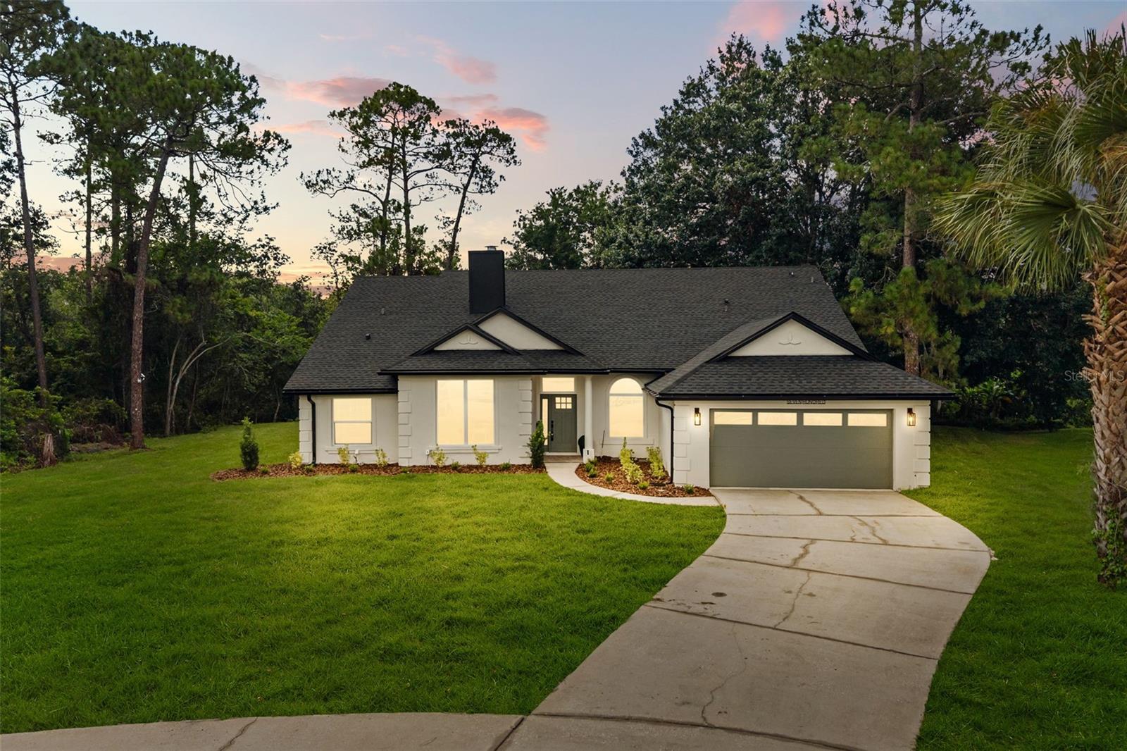 Welcome to 700 W Pinewood Court, an extraordinarily reimagined contemporary residence tucked away at the end of a quiet cul-de-sac on a private conservation homesite. Offering 4 bedrooms, 3 bathrooms, and 2,350 square feet, this exceptional pool home has been transformed with luxurious finishes and modern design.

From the moment you step inside, soaring vaulted ceilings and abundant natural light create a lasting first impression. The open floor plan is anchored by a stunning double-sided fireplace that beautifully connects the living room with a versatile office or flex space, creating warmth and architectural character from every angle. Brand new flooring, interior doors, trim, designer lighting, and fresh contemporary finishes flow seamlessly throughout the home.

The kitchen is designed for both entertaining and everyday living, featuring elegant quartz countertops, a large center island, premium modern appliances, porcelain tile accents, generous storage, and a casual eat-in dining area. Just beyond, the fully enclosed (and air conditioned!) Florida room provides an additional year-round living space that overlooks the sparkling pool and offers endless flexibility as a lounge, game room, or entertaining space.

Occupying its own private wing of the home, the expansive primary suite serves as a luxurious retreat. The primary bathroom showcases dual vanities, a freestanding soaking tub, oversized glass-enclosed shower, premium fixtures, and thoughtfully designed finishes that rival a luxury resort. 

Outside, the pool enclosure features brand-new screens with updated pool equipment to keep maintenance simple. Fresh sod blankets the entire property, complemented by an updated irrigation system and peaceful conservation views. Adding even more appeal, the property is located within a deed-restricted community while NOT being subject to HOA rules, offering the character and consistency of an established neighborhood with added flexibility for homeowners. 

The extensive list of improvements provides tremendous peace of mind for years to come, including plumbing updates (2026), electrical updates (2026), water heater (2026), all new windows, and more. Plus, the septic system was evaluated and pumped in 2026, and features a newly installed septic alarm system.

Perfectly positioned in one of Lake Mary's most desirable locations, you'll enjoy quick access to Historic Downtown Lake Mary, Timacuan Golf & Country Club, Trailblazer Park, and Lake Mary Sports Complex. Luxury, privacy, modern design, and complete peace of mind come together in this exceptional Lake Mary residence.