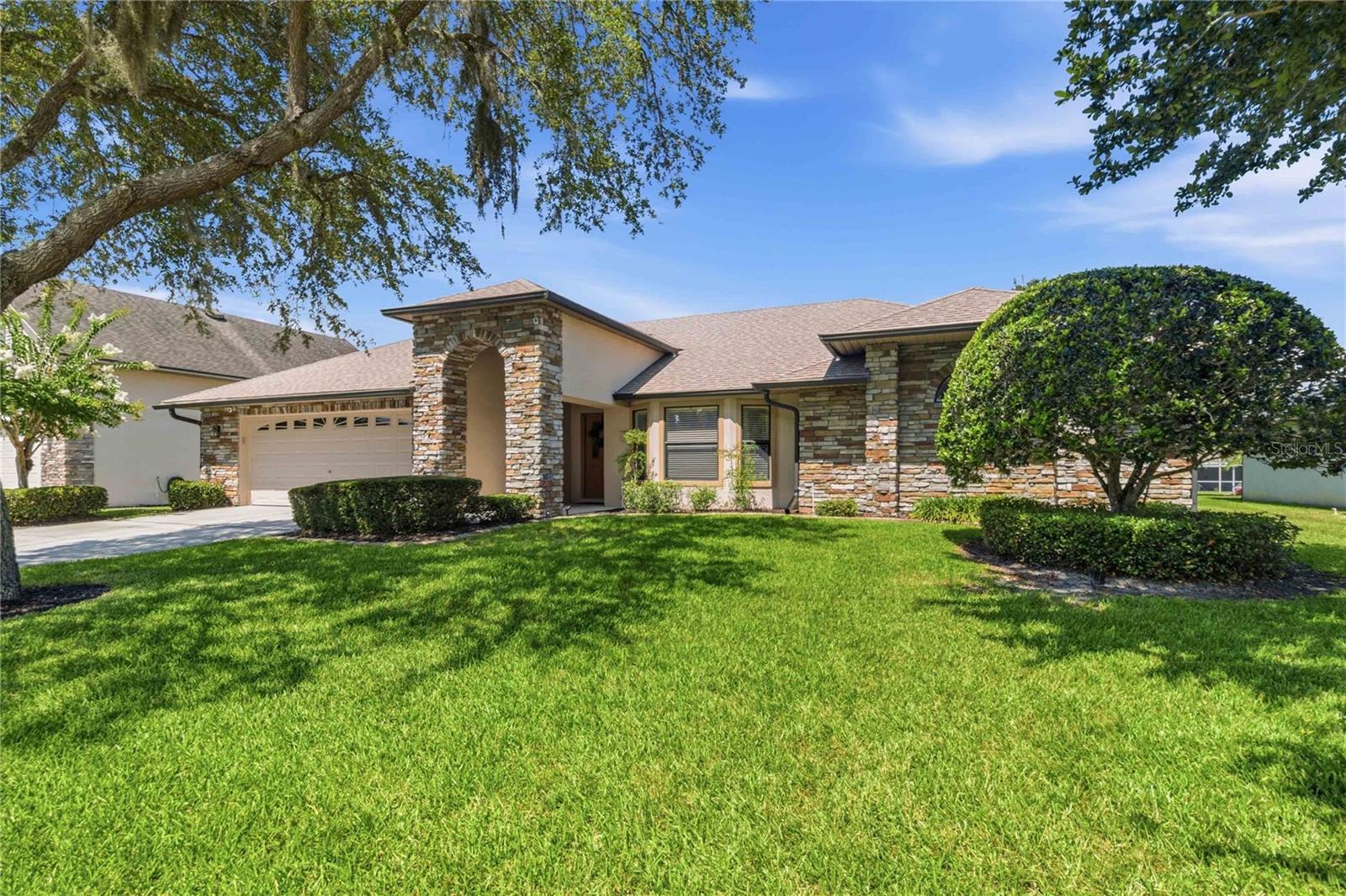 Welcome to 122 Lena Ann Drive in the highly sought-after gated community of East Lake Reserve in St. Cloud. This 4-bedroom, 2-bath home offers an oversized garage, a functional split floor plan, oversized living and family rooms, a screened pool, and numerous recent upgrades.

From the moment you arrive, you'll appreciate the beautiful curb appeal featuring stone architectural accents, mature landscaping, and a welcoming front porch. Inside, natural light fills the spacious living areas, creating an inviting atmosphere throughout.

The kitchen serves as the heart of the home, overlooking the breakfast nook, family room, covered patio, and pool area. The split-bedroom layout provides both privacy and functionality. On one side of the home are three generously sized guest bedrooms, each featuring double closets, along with a guest bathroom that offers convenient pool access and features quartz countertops and custom cabinetry.

Privately located on the opposite side of the home, the primary suite offers direct access to the pool through large sliding glass doors. The primary bathroom features quartz countertops and custom cabinetry, while the walk-in closet includes custom built-ins and abundant storage space.

Step outside to enjoy the screened, custom-designed pool surrounded by pavers and a spacious covered patio, creating the perfect setting for outdoor entertaining. The oversized garage provides ample room for vehicles, storage, tools, and hobbies. An additional air-conditioned utility room houses the HVAC handler, updated oversized 80-gallon water heater, and utility sink.

Recent upgrades include:
• New roof (2026)
• Quartz countertops throughout (2026)
• Bathrooms featuring quartz countertops and custom cabinetry
• Whole-home water softener system (2024)
• HVAC replacement (2020)
• Generator-ready connection

East Lake Reserve is one of St. Cloud's premier gated communities located along East Lake Tohopekaliga, known for world-class fishing, boating, and natural beauty. Residents enjoy a scenic lakeside boardwalk, community dock, basketball courts, playground, and secure boat and RV storage.

Conveniently located between Lake Nona and Downtown St. Cloud, you'll enjoy easy access to Medical City, Orlando International Airport, UCF, shopping, dining, entertainment, SR-417, SR-528, and Florida's Turnpike. Don't miss out on this opportunity schedule your showing today.