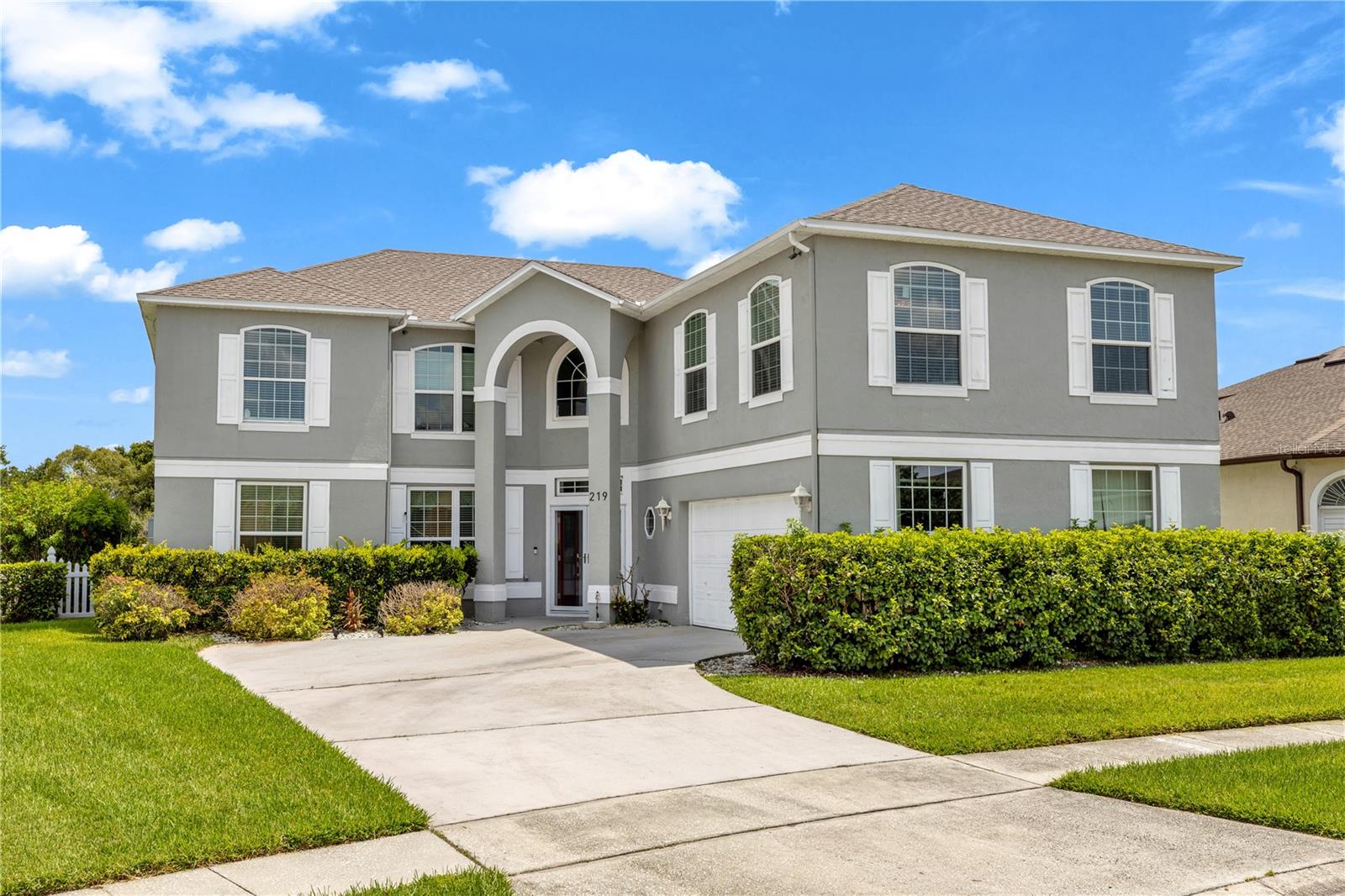 Experience the ultimate in luxury living with this stunning 5-bedroom, 3-bathroom home, perfectly situated on the 13th hole of the coveted Remington golf community. Spanning 3,897 square feet on a spacious .28-acre fenced lot, this residence boasts breathtaking golf course and waterfront views, complete with your own private screened-in pool. Step inside to discover an inviting open layout featuring a grand entry illuminated by elegant chandeliers. The first floor offers a comfortable living area, an eat-in island kitchen overlooking the oversized family room, and a guest bedroom ideal for visitors or in-laws. The second floor houses the expansive primary suite, which includes a private balcony for serene morning or evening retreats, an en-suite bathroom with a luxurious soaking tub, double vanity sinks, and a separate shower. A generous bonus room, currently utilized as a home theater, adds to the home's appeal, providing ample space for relaxation and entertainment. Recent updates include a newer roof and water heater, both installed in 2023, along with a newer A/C system and a recent water softener. The property has been meticulously maintained by its owner, ensuring its pristine condition. Remington offers resort-style amenities, including golf, tennis, a community pool, and scenic walking trails, all within a gated community. Conveniently located near the Orlando International Airport, Florida Turnpike, Lake Nona Medical City, shopping, and the magical attractions of Disney, this home is the perfect blend of comfort, elegance, and leisure.