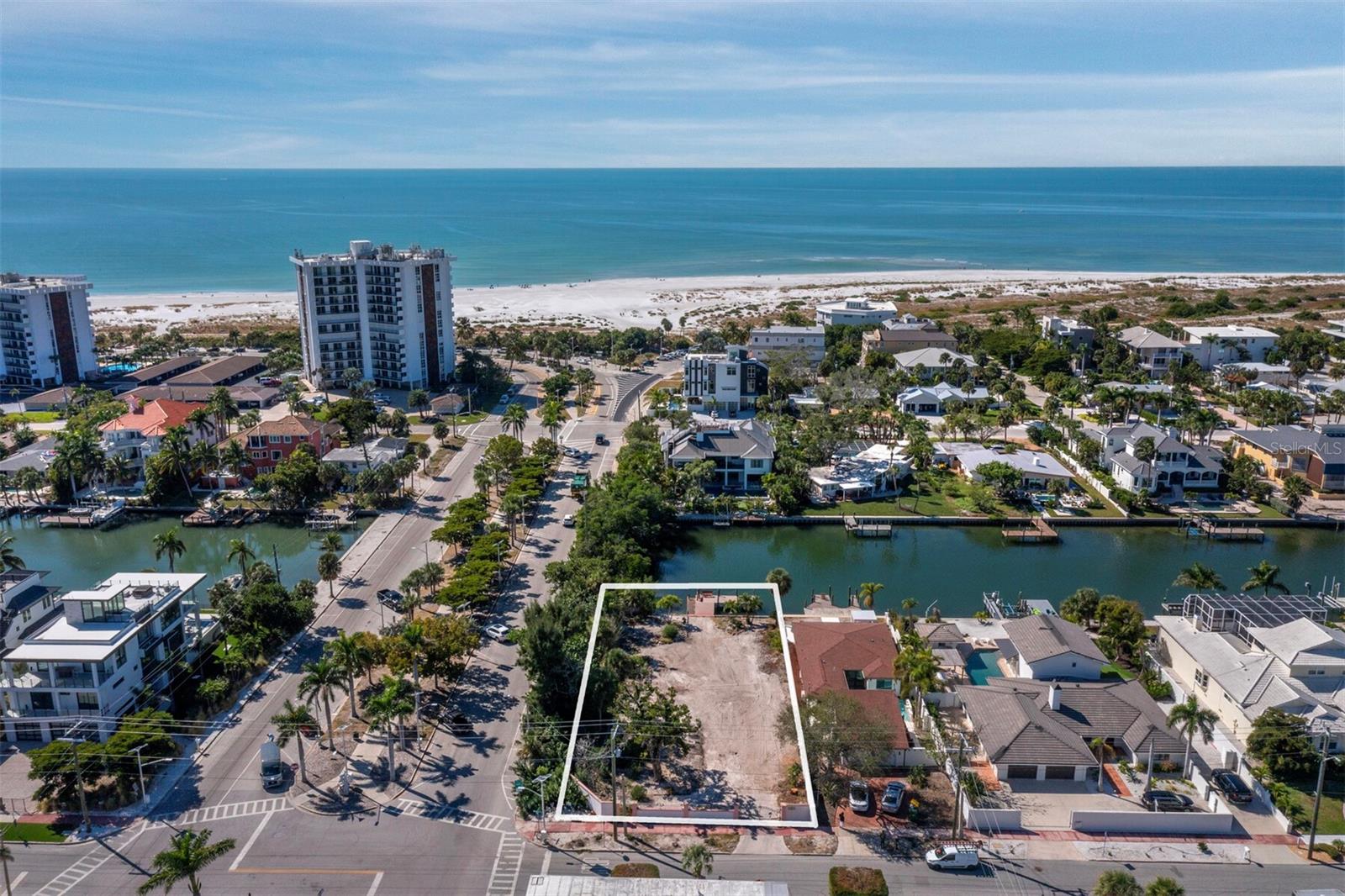 The first time this parcel has been available in almost 40 years! This large corner lot is only one block to the beach. It is already gated and walled, with a dock and seawall. Bring your builder and create more memories on this landmark, oversized property. Situated on a quiet canal leading into Pansy Bayou, where manatees and fish are plentiful. The waterfront location is perfect for a small motorboat and kayaking. The entry faces N. Washington and the address could be changed to reflect the N. Washington location. Recreation is endless with this waterfront canal and close to the beach location, with restaurants and shopping at your doorstep. You can have it all here!