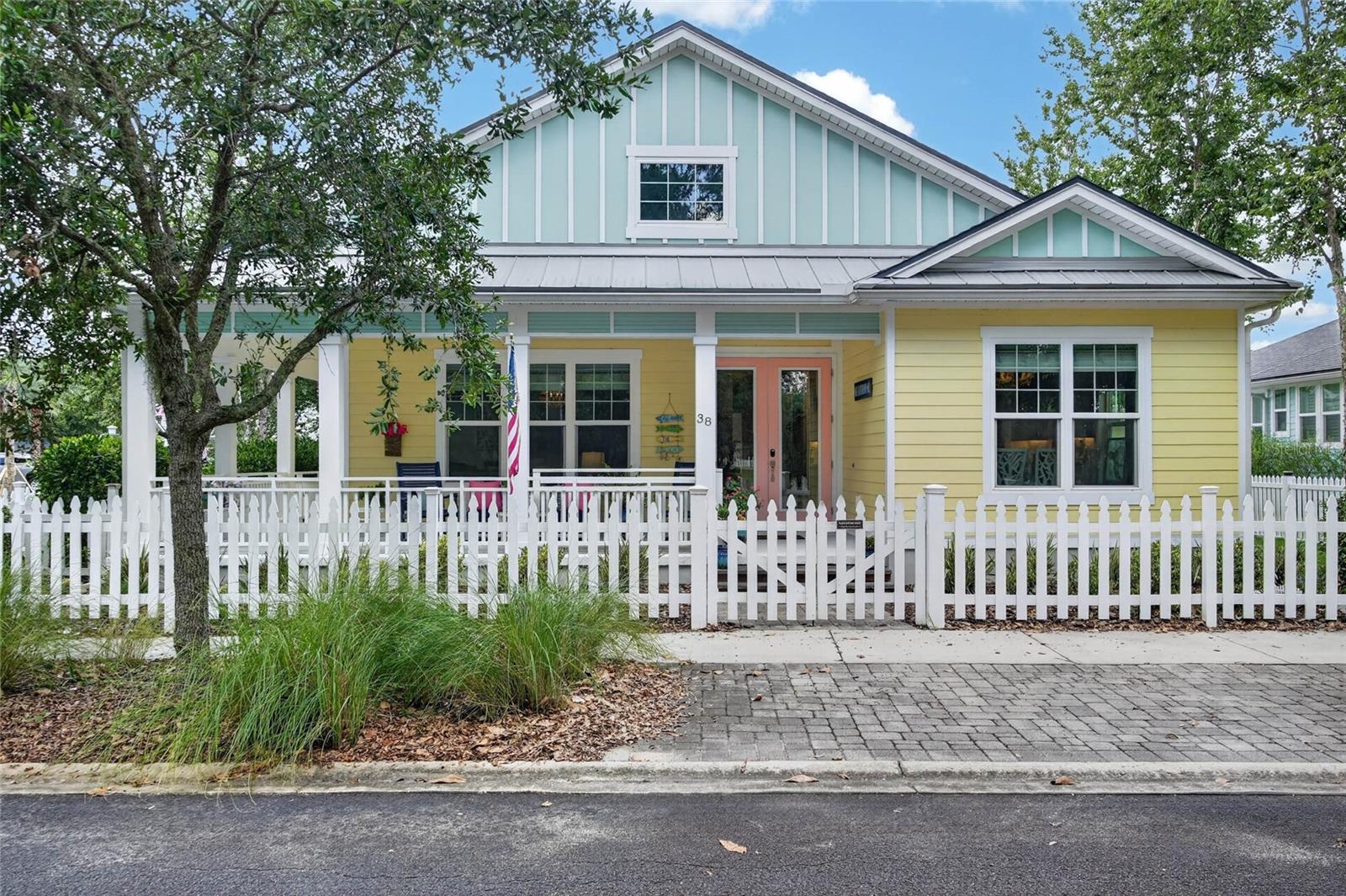 The salt air finds you first. Then the shade of a corner lot, the glimmer of pond water through the trees, and the slow exhale that comes with knowing — this is the one.
Built for those who understand that coastal living isn't an aesthetic, it's a way of life, this Key West cottage on Laughing Gull Lane delivers the rare combination of thoughtful design and craftsmanship and effortless outdoor living. Enjoy a day at the beach or the resort style community pool -head home and rinse off under the outdoor shower, pour something cold, and settle into the screened paver lanai as the fire pit crackles and the evening softens around you. Enjoy peace of mind with hurricane windows and doors and stem wall foundation. 
Inside, the details speak quietly but clearly — 10' ceilings, solid core doors, two-step crown molding, porcelain wood-look tile throughout and built-in speakers for music that follows you from the kitchen to the porch without missing a beat. The chef's kitchen is built for those who cook with intention — KitchenAid commercial style appliances, 6-burner gas, pot filler, dovetail cabinetry with pull-out shelving and spice storage. Nothing cluttered. Nothing overlooked.
The owner's suite is your anchor — insulated for true quiet, outfitted with a custom closet, sitting area, and a French door that opens to the wraparound porch where mornings are best spent doing nothing at all.
Guests settle in easily. The yard is fenced and private. The garage is oversized and insulated. Security is wired. New A/C and refrigerator in 2024. Buyer To Verify Measurements.
Some come and vacation here. Others are smart enough to stay. Come Discover 38 Laughing Gull Ln nestled inside of Beach Haven along scenic A1A- just 8 miles from Crescent Beach and a mile south of Marineland.