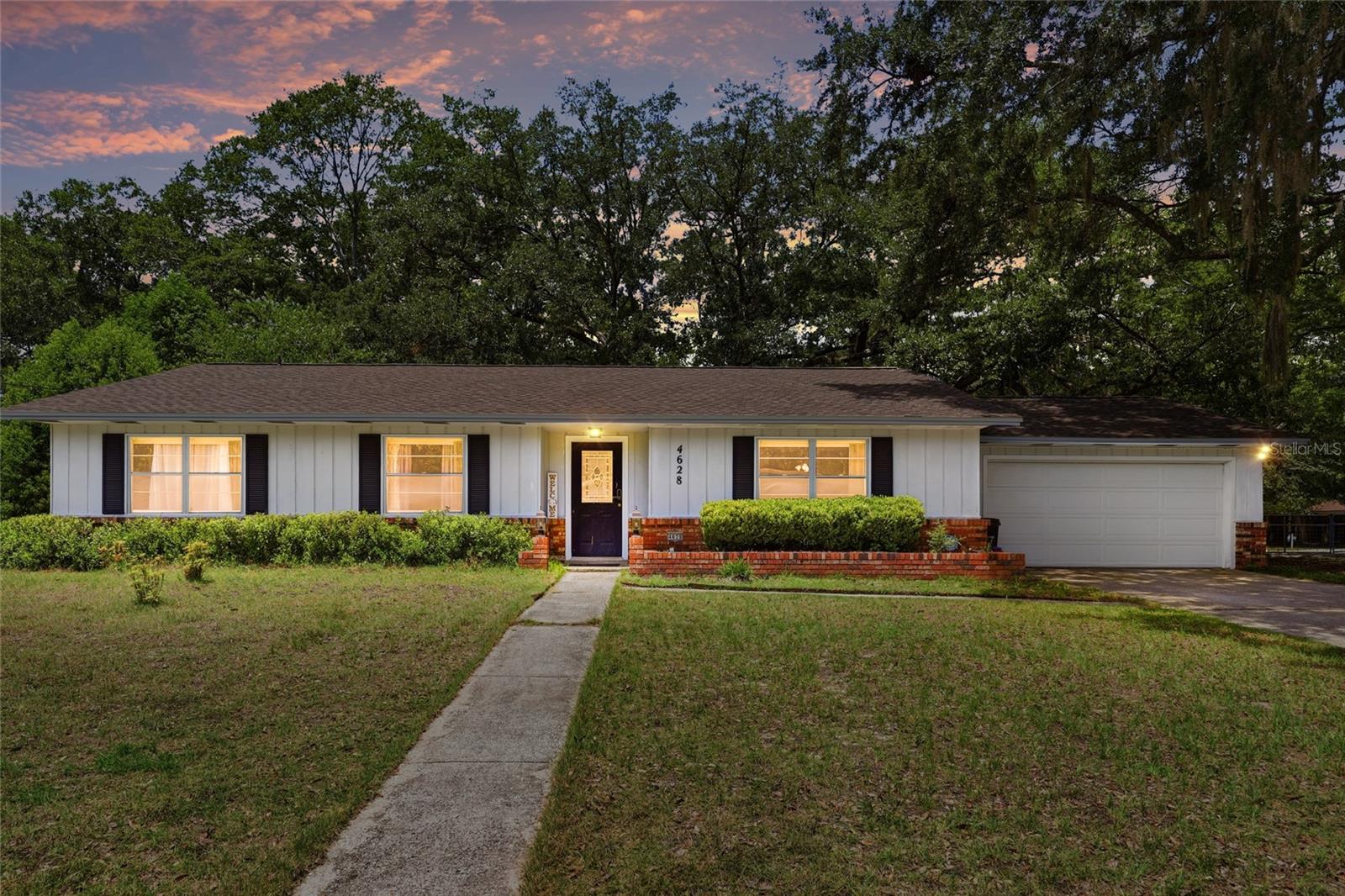 Welcome home to this move in ready 4 bedroom, 2 bath home nestled on a spacious .37 acre lot in Northwood West. Recent updates include new roof (2025), new HVAC (2024), new water heater (2023) and new LVP in the living room and bedroom (2025). Step inside to discover a bright, open concept layout. With ample space in the living room, there’s room for a formal living room, office or flex space and a pocket door that leads into the kitchen. The kitchen features stainless steel appliances, abundant counter space, and a functional design that flows seamlessly into the dining area, where large windows fill the home with natural light. Down the hall you find a wide hallway closet for convenient storage leading to the primary bedroom, three generously sized bedrooms and updated bathrooms that showcase modern finishes. Outside, the expansive backyard offers endless possibilities for relaxing, gardening and shade from the mature trees. Unbeatable location, just 4 minutes to Publix in Hunter’s Crossing, nearby shopping, restaurants, and Possum Creek Park; only 5 miles to UF; and about 20 mins to UF Health/Shands Hospital and VA medical facilities. Plus, the home is just a 5 minute drive to top-rated Talbot Elementary School. Come see this exceptional Northwest Gainesville home for yourself!