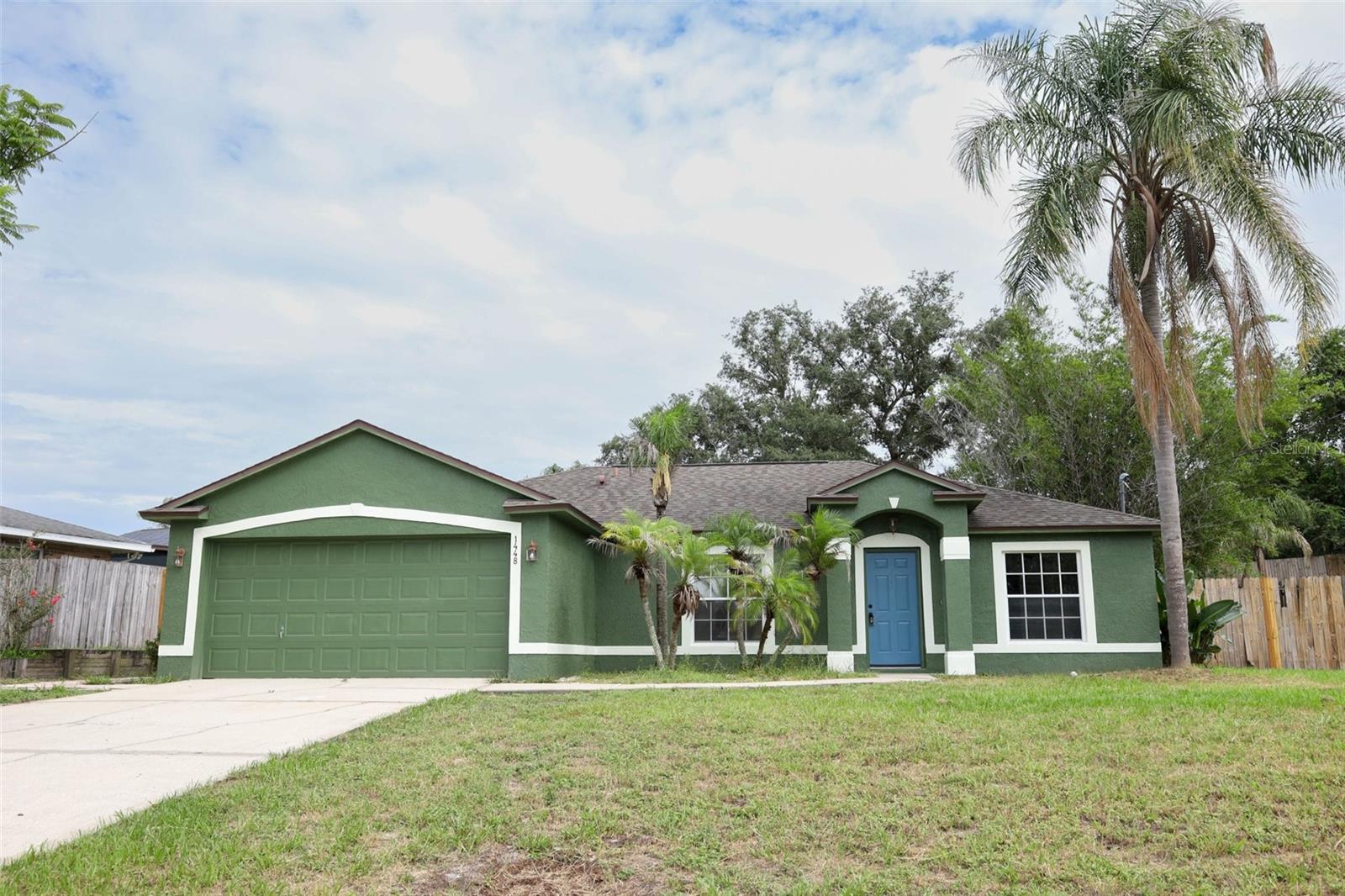 Virtually Staged. Check out this great home in the heart of Deltona~ Pack your bags & move in! Freshly painted inside & out, along with BRAND NEW LPV flooring throughout, no need to worry about flooring for a long time! Brand new sliding glass door to the large open brick patio & fully fenced back yard!  This split-plan home has a large family room/kitchen combo in the middle, with a large counter island, room for 6 barstools.  The inside utility room has storage space.  The bathrooms have granite counters and have been redone. Each bedroom has a large closet with built-in shelves & a storage racks. The primary bedroom has an extra-large closet (11x5.5) with lots of storage options. The primary bathroom has a large walk-in shower with a granite countertop. Do not miss the great home. Call today for a private showing.