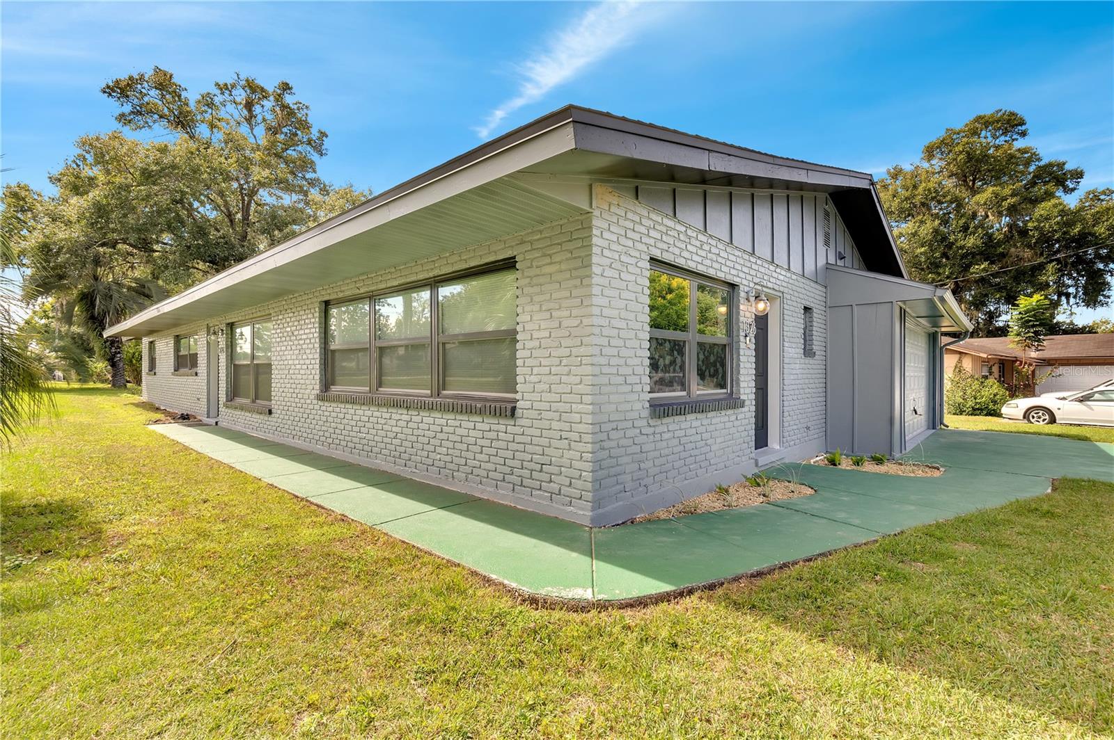 Price Drop. Owner is motivated. Welcome to a renovated, mid-century home located in Southeast Ocala. This spacious 3 bedroom, 2 bathroom home has been updated with new windows in 2021 and a new water heater in 2022. The electrical was also updated 2021.  The roof was replaced in 2018. Luxury vinyl plank floors, fresh interior paint, newer kitchen cabinets, granite countertops, stainless steel appliances and glass tile backsplash can be found throughout. The oversized family/living room features textured walls commonly seen on HDTV. The bathrooms have been remodeled; the master features a fully tiled walk-in shower with new flooring, newer glass shower door, two vanities, double rain shower heads with sprayers, updated lighting, updated plumbing and a new toilet. The second bathroom features a new tub, subway shower tile, new shower hardware, new vanity, updated lighting, updated plumbing and a new toilet. The washer/dryer hook-ups are located in the utility room just off the epoxied two-car garage. The screened back patio allows for plenty of space to relax after a long day. Loan is assumable if buyer qualifies with lender. LOW interest rate.