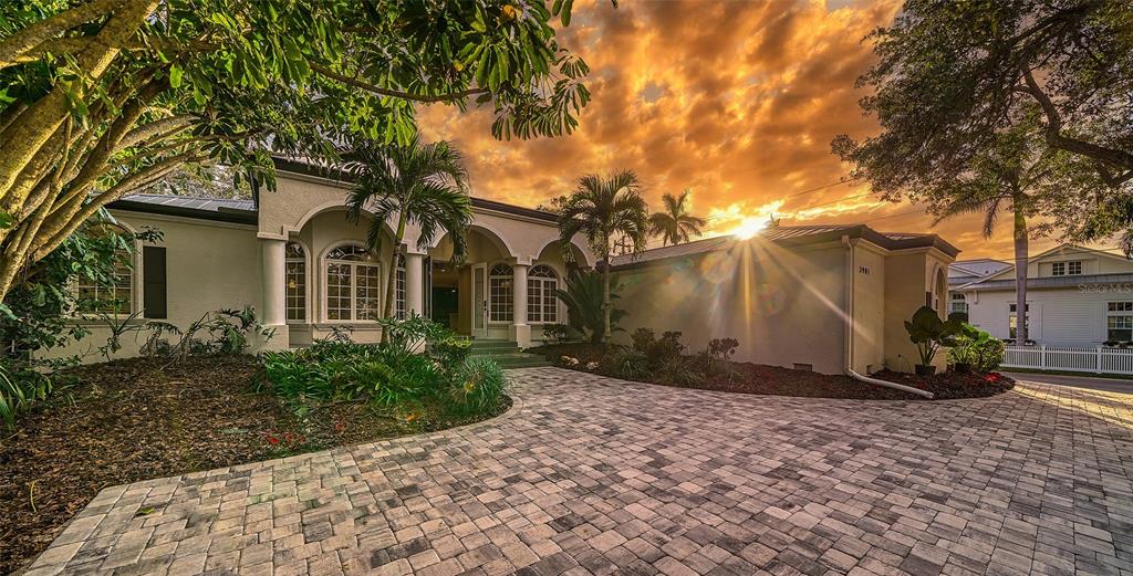 "West of Trail" beauty is now freshly remodeled with a brand-new roof, yes a BRAND NEW ROOF!  This 3500+ square foot home was originally built by Vision Homes in 2002 and is nestled on a private 20,000 square foot lot with lush landscaping, beautiful mature tress and a south facing backyard. New exterior paint and interior paint along with a gorgeous new interior make this home feel like it's brand new! 
Highlights include new engineered wood flooring throughout and exquisite new lighting and ceiling fans.  Boasting four bedrooms and a study this home has the perfect split floorplan with the primary wing on the east side of the home and the remaining three bedrooms, family room and laundry on the west side.  The kitchen features new shaker style cabinets with gleaming quartz counters, marble backsplash, new GE Cafe stainless appliances and a walk in pantry.  The primary suite is grand with french doors to the pool and spa, two bathrooms and large walk in closets!  The study is in the front of the house with French doors and a beautiful view of the east and early morning sun.  The living room has a wood burning fireplace and entrance to one of the two covered areas outside!   The outside space also offers a fireplace and has been updated with new pavers, new pool surface, new pool tile and new pool equipment!  The pool cage has been painted and totally rescreened! You will fall in love with the feature wall located in the family room with new electric fireplace, huge built in television and decorative wood detail!  The family room sliders pocket, so entertaining is a continuous flow inside to outside enjoying multiple covered areas and complete privacy. Guest bedrooms #2 & #3 have walk in closet and share a jack and jill bath with dual sinks.  Bedroom #4 is conveniently located next to a full bath and has it's own entrance in the rear of the home, making it a perfect secondary study. The Laundry room has a new washer & dryer and you will love the additional cabinetry upon entering the home from the garage.  Both air conditioners are brand new and a new hot water heater has been added as well! This magical setting is unique with beautiful landscaping and nestled within a tropical paradise with total privacy. An oversized lot west of trail is rare There are three  parking areas and a two car garage. This home is in one of Sarasota's most treasured neighborhoods with easy access to Siesta Key, Southside Village and Tamiami Trail.  If you are looking for immediate occupancy, look no further as paradise awaits but won't last long!  Call for your private tour today!