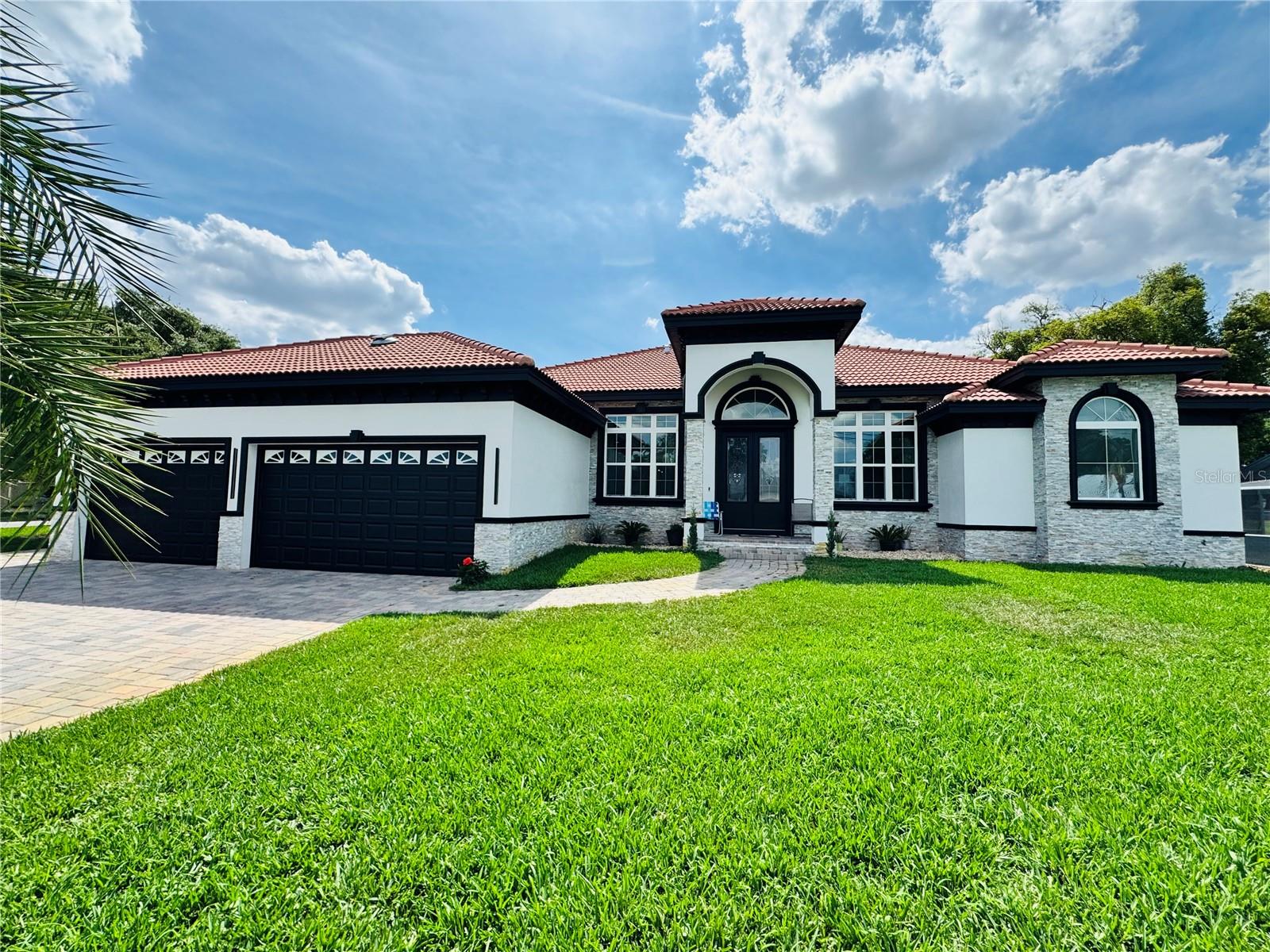 Experience luxury living in this newly built (2023) modern style home featuring breathtaking views of Lake Jessie and no HOA! This spacious 4-bedroom, 4-bath single-family residence offers an expansive open floor plan, soaring ceilings, and porcelain tile throughout. The elegant living room features a dramatic porcelain tile fireplace, creating a warm and stylish focal point. The chef’s kitchen is designed to impress with quartz countertops, stainless steel appliances, sleek modern cabinetry, and ample storage. A spacious indoor laundry room adds everyday convenience.
Additional highlights include a 3-car garage, durable tile roof, whole-home water filtration system, and pre-wiring for a security camera system. Enjoy year-round outdoor living with a fully enclosed porch and large paver patio—perfect for relaxing or entertaining. Conveniently located directly across from a public boat ramp, offering easy access to boating and recreation without the upkeep of lakefront ownership.
An exceptional opportunity to own a move-in-ready home with thoughtful upgrades, modern design, and a prime location near the water. Schedule your private showing today!