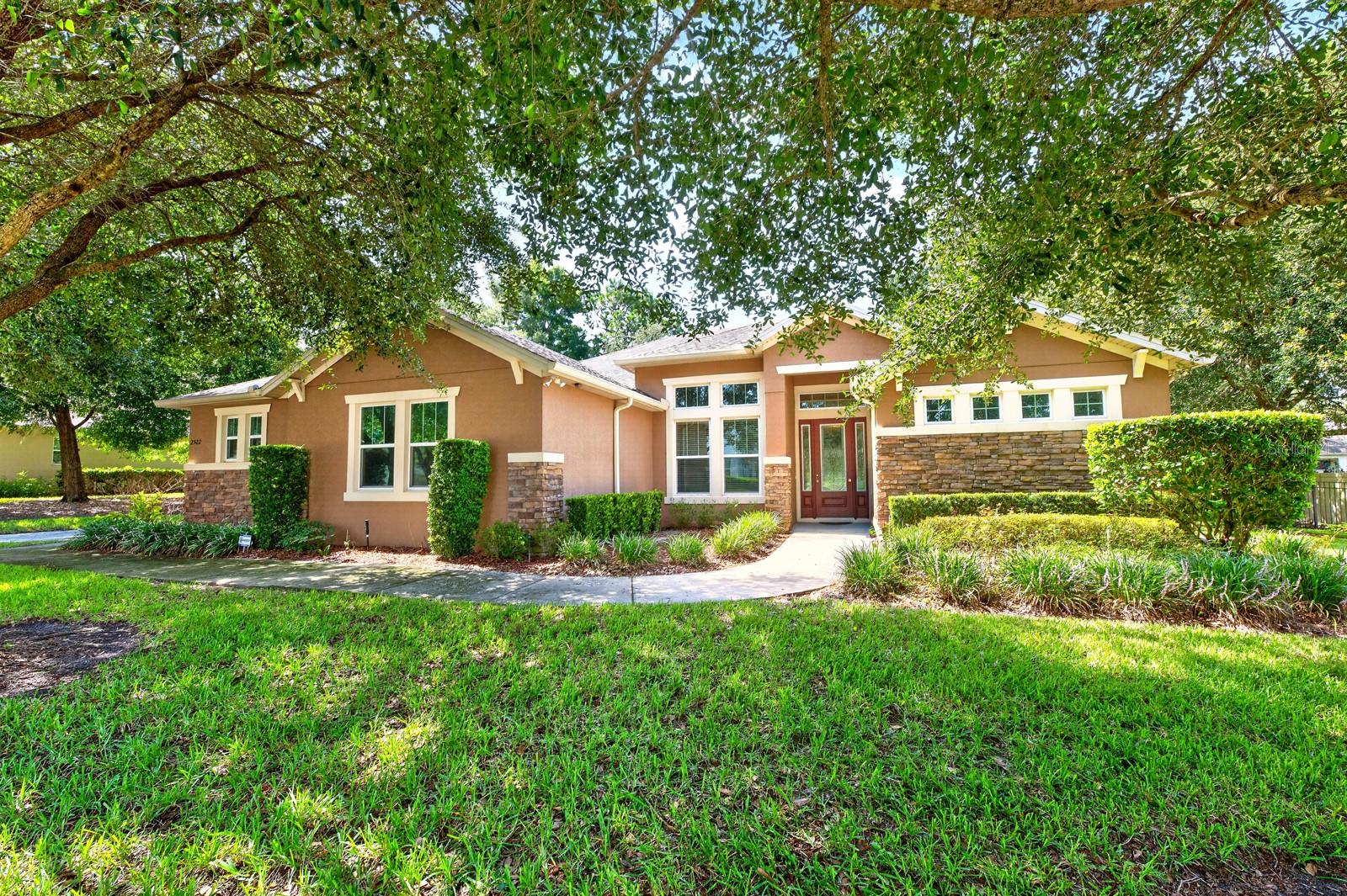 Virtually Staged. Seller may consider buyer concessions if made in an offer ~ Set on a beautifully landscaped 1/3 ACRE LOT (.37) in the GATED Oak Ridge community of Apopka, this spacious 4-bedroom + office, 3-bath home offers the perfect blend of flexible living spaces, timeless design, and room to grow! From the moment you arrive, the side-entry 3-CAR GARAGE, mature landscaping, and inviting curb appeal make a lasting first impression. Step inside to discover high ceilings, abundant natural light, and a thoughtfully designed 3-WAY SPLIT FLOOR PLAN with a dedicated office, creating the ideal layout for today's lifestyle. Formal living and dining rooms greet you at the front of the home, while the heart of the home opens into a generous family room and casual dining nook designed for everyday living and effortless entertaining. The well-appointed kitchen delivers everything you need with rich wood cabinetry, STAINLESS STEEL  including a BUILT-IN WALL OVEN, a center ISLAND with bar seating, a separate breakfast bar, pantry storage, pendant and recessed lighting, and seamless sightlines into the breakfast nook and family room. Sliding glass doors extend the living space onto the SCREENED LANAI, creating the perfect INDOOR/OUTDOOR flow. The PRIMARY SUITE is located on its own wing for maximum privacy and features an impressive walk-through OVERSIZED WALK-IN CLOSET along with a spacious en-suite bath complete with a massive DOUBLE WALK-IN SHOWER featuring built-in seating. Three additional bedrooms are located on the opposite side of the home alongside two full baths, including one with direct exterior access – already perfectly positioned for a future pool. Outside, the screened lanai overlooks a lush backyard framed by MATURE TREES that create a peaceful, park-like setting. An ADDITIONAL PATIO beyond the screened enclosure provides even more space to relax, grill, or entertain while enjoying the large lot. A noteworthy highlight is the spacious laundry room with built-in cabinetry on both sides and utility sink. Conveniently located just minutes from SR 429, shopping, dining, the Northwest Recreation Complex, sports fields, basketball courts, parks, and everyday conveniences, this exceptional Oak Ridge home delivers the space, location, and layout you have been searching for. Call today to schedule a tour and let us say WELCOME HOME!