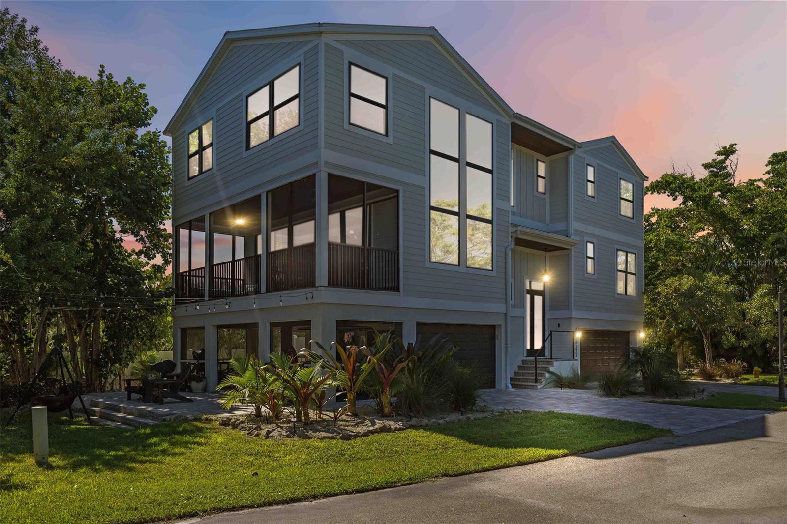 Welcome to Laguna Yacht Village on beautiful Longboat Key- a gated waterfront community located across the street from the beach, with private bay access.  This fully furnished turnkey home is perfectly positioned to embrace the island lifestyle, with fantastic gulf views from almost every room.  The home includes a deeded deep-water dock (Slip #6- boat lift included), located in a protected lagoon just minutes from the Intracoastal Waterway and Gulf of Mexico with no fixed bridges, making it a boater’s dream. This modern Key West inspired three story single residence with an oversized 3-car garage features four bedrooms, three full baths, and over 2,886 square feet of beautifully designed living space.

Perfectly positioned to embrace the island lifestyle, this home includes a deeded deep-water dock (Slip #6) located in a protected lagoon just minutes from the Intracoastal Waterway and Gulf of Mexico — with no fixed bridges, making it a boater’s dream. Step inside and experience a harmonious blend of coastal elegance and comfort. Expansive living areas feature soaring ceilings, an abundance of natural light, and sophisticated finishes throughout.

The culinary-inspired kitchen, designed in timeless style, boasts custom cabinetry, quartz countertops, and an oversized central island — the ideal space for hosting and entertaining. The primary suite, complete with a study, serves as a serene retreat with dual vanities, a hydro-massage soaking tub, and a walk-in glass-enclosed shower for the ultimate spa-like experience.

Multiple balconies, including an elevated screened patio off the main level, provide refreshing sea breezes and captivating water views of the Gulf. A ground-floor patio further extends the outdoor living experience. The oversized garage provides ample storage for beach gear and boating essentials.

The gated community features a resort-style pool offering a true lock-and-leave lifestyle. Residents will appreciate convenient proximity to Longboat Key’s pristine beach, award-winning island restaurants, boutique shopping, and parks — all while being a short drive from the cultural heart of downtown Sarasota and St. Armands Circle.