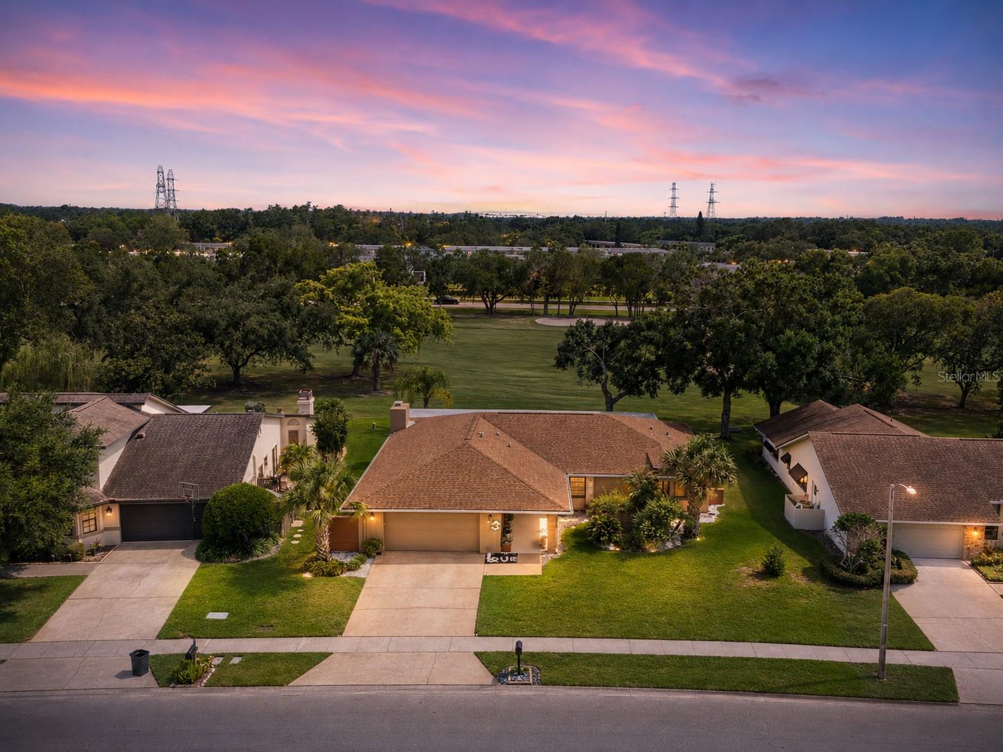 Welcome to 450 Cypress Creek Circle, a beautifully renovated single-story home nestled within the prestigious gated community of East Lake Woodlands. Perfectly positioned on the golf course, this exceptional residence enjoys wide-open fairway views of hole #2 on the South Course at Ardea Country club with no homes directly behind, creating a peaceful backdrop for everyday living and entertaining. Thoughtfully updated throughout in 2020, this three-bedroom, two-and-a-half-bath home offers the perfect blend of timeless elegance and modern comfort. The spacious floor plan features formal living and dining rooms, a welcoming family room with a dramatic floor-to-ceiling wood-burning fireplace, and multiple sliding glass doors that seamlessly connect the indoor living spaces to the expansive screened lanai. The beautifully updated kitchen showcases quartz countertops, stainless steel appliances, abundant cabinetry, recessed lighting, and an oversized breakfast bar—perfect for gathering with family and friends. The private primary suite offers direct lanai access, a beautifully renovated bath, and a custom walk-in closet, while the guest bath and powder room have also been tastefully remodeled. Stretching nearly the length of the home, the oversized covered and screened lanai is the perfect place to enjoy your morning coffee, unwind with evening sunsets, or entertain while taking in the panoramic golf course views. The spacious backyard offers plenty of room to add a private pool and create your own private outdoor retreat. Major improvements completed in 2020 include the roof, HVAC system, interior and exterior paint, and extensive interior renovations, providing buyers with added peace of mind. Residents of East Lake Woodlands enjoy beautifully maintained streets, mature landscaping, 24-hour guarded gate access, and optional membership opportunities at the newly renovated Ardea Country Club, featuring 36 holes of championship golf, tennis, pickleball, fitness facilities, swimming pools, exceptional dining, and a vibrant social calendar. Conveniently located just minutes from Boot Ranch shopping, restaurants, parks, Gulf beaches, Tampa International Airport, and everything the Tampa Bay area has to offer, this move-in-ready home delivers the Florida lifestyle you’ve been waiting for.