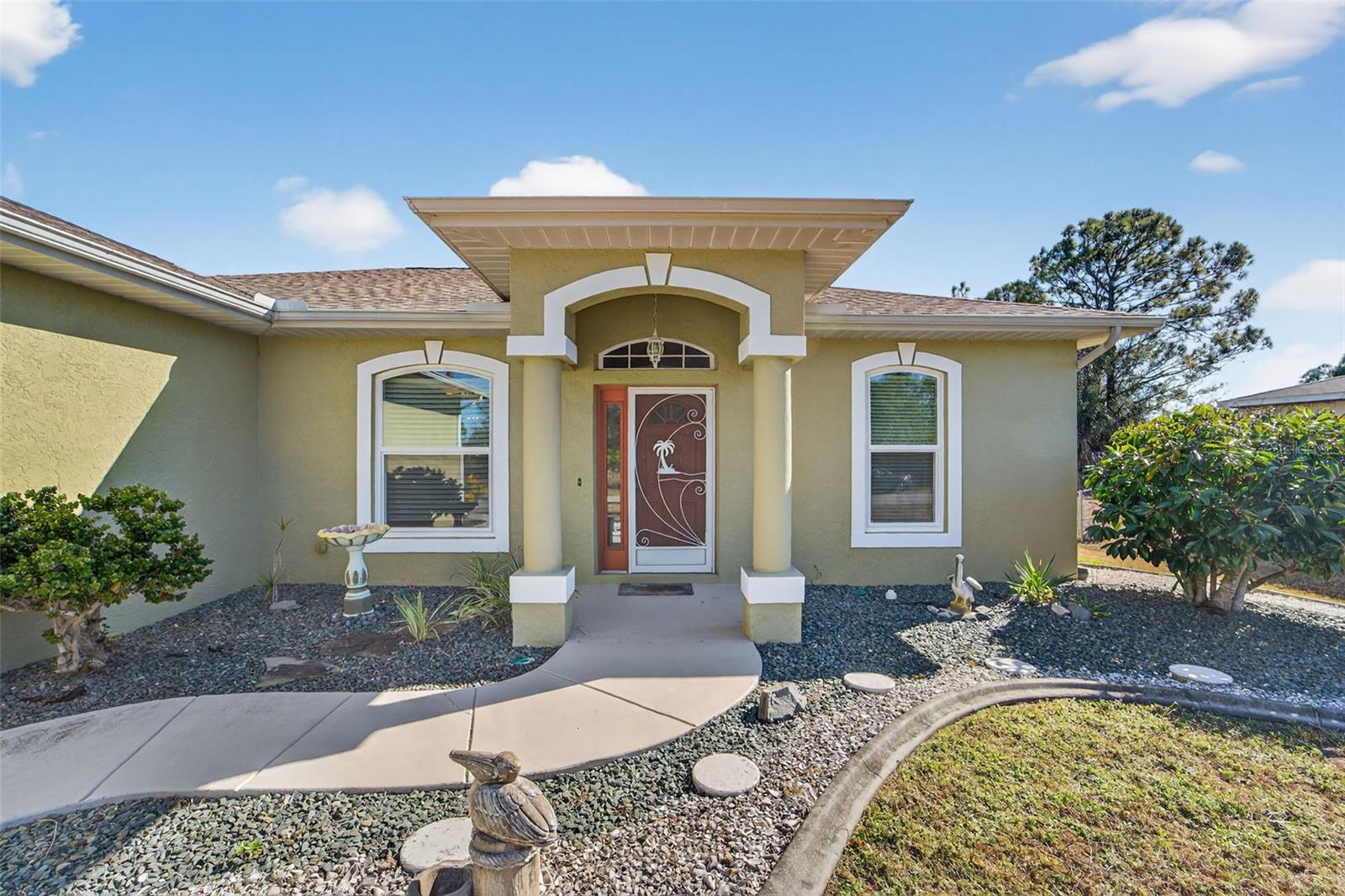 SOMETHING FOR MOM, DAD AND THE WHOLE FAMILY!   This beautifully appointed Windemere built home ON A LARGE DOUBLE LOT offers over 1,800sq feet of living space PLUS A SEPARATE 1,200 sq ft WORKSHOP.  Truly a showpiece with numerous custom features, all nestled in on a one-half acre lot! Plan on spending some time in this home when you first visit, Enter through the front door and step into your own private stress-free sanctuary.  Outdoor entertainment can be enjoyed on the back deck. The light and bright kitchen boasts plenty of cabinet space, tile floors and solid surface counter tops.  Adjacent to the Livingroom you will find an 18'X 20' Family Room.  The Primary Bedroom Suite offers walk-in closet and Ensuite bathroom double sink vanity and walk-in shower. The two guest bedrooms and guest bathroom offer plenty of space for guests and family. Endless features such as formal dining & living room with decorator fans and light fixtures Plus, a DETACHED 1,200+sq foot workshop built on an adjacent lot with its own separate driveway and a separate storage shed. NEW ROOF 2023 AND NEW STORM WINDOWS 2025.  Whether you're enjoying quiet mornings on the back deck or entertaining guests in your spacious Family Room, this well-built home offers the perfect blend of beauty, function, and Florida lifestyle which makes this a true gem. Don't let this one get away! Contact us today to schedule your private showing.