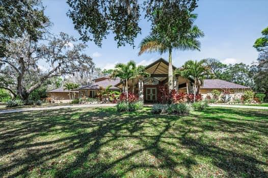 Discover an executive estate offering an impeccably designed living space that seamlessly blends luxury, comfort, and sophistication. Located in the heart of Pinellas, this hidden gem community features approximately 70 estate-style properties, each situated on expansive 2+-5 acre lots. This custom home, a true masterpiece with almost 6000 living space and gross area 7386, is set on a sprawling 2.2 -acre lot and includes a personal park-style backyard with vast open land—ideal for adding recreational courts and enjoying outdoor activities. The open-concept design is perfect for both large-scale entertaining and everyday elegance, with pride in ownership evident throughout. From the moment you arrive, the stately façade, symmetrical proportions, and classic entryway set the tone for the elegance within. Guests are welcomed by a grand foyer that highlights the home’s custom details, with each room curated to create an atmosphere of understated luxury. The formal living and family rooms provide the perfect setting for elegant entertainment, featuring three wood fireplaces. The kitchen boasts top-of-the-line stainless steel appliances, a center island with a vent hood, granite counters, marble flooring, a built-in refrigerator, and a double oven. The gourmet kitchen island creates a chef’s paradise that is both functional and beautiful, offering ample space for culinary creations and casual gatherings. The expansive living room accommodates an oversized sitting area overlooking the 9-foot deep pool, which holds approximately 33,000 gallons and measures 24 x 45 feet, your private tennis court and a serene backyard oasis. The formal dining area comfortably seats a large family, making it ideal for hosting unforgettable events. Quality at the highest  kitchen offers double sink ceramic stone and cooper faucets. The thoughtfully designed split-bedroom floor plan ensures excellent privacy. The luxurious ground-floor primary suite offers dual walk-in closets, custom made chandeliers, and custom hand painted ceiling with gold leaves. An oversized bonus room on the main level, previously used as a music/playroom, can be converted into an office, sitting room, or any space desired. The second level features 5 bedrooms, 4 full baths, 1 half bath, 2 dining rooms, a bonus room, a study room and 3 wooded fireplaces in kitchen, main room and living room. There are 2 master Bedrooms on the main floor with their own bathrooms. Home is equipped with speaker and music sound system throughout. An outdoor covered kitchen invites you to enjoy al fresco dining, while generous lounging areas provide the perfect backdrop for relaxation and entertainment. Plenty of space on the property to add additional space garage room if need it for additional space. This estate perfectly balances elegance, functionality, and serenity. Roof replaced 2020. Windows replaced 2014. Pool resurfaced 2014, Situated in the heart of Clearwater, this home combines the best of both worlds: a private retreat among million-dollar homes in a secluded neighborhood, yet centrally located for easy access with in 15-20 minutes to the Clearwater Beach and the surrounding beaches, shopping, restaurants,  Tampa International Airport, St Petersburg. The property is high and dry. This outstanding home and property, full of charm and character, awaits a special owner seeking something unique, grand, and one-of-a-kind. Welcome to your very own slice of paradise in the Sunshine State!