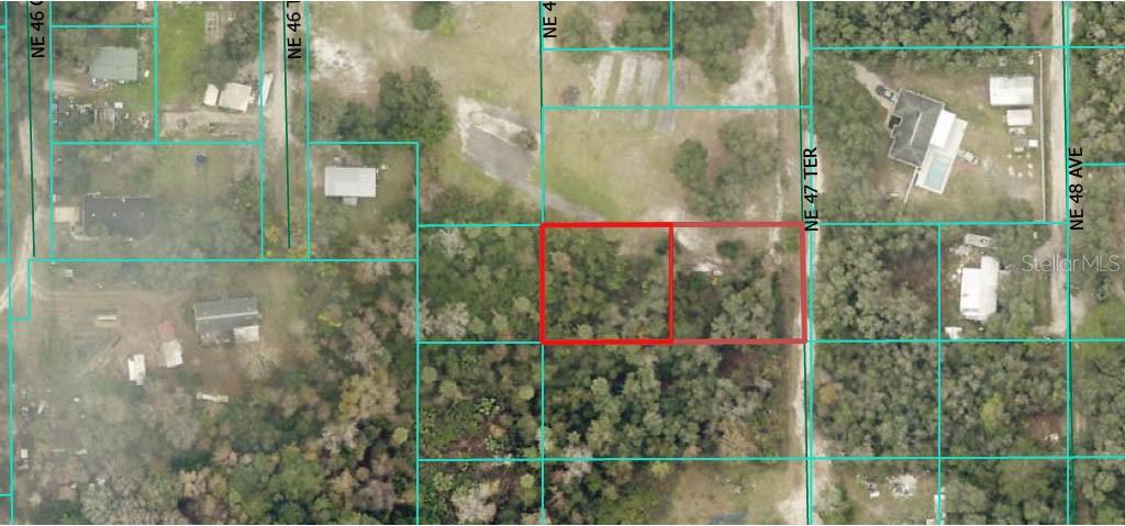 Two adjoining lots totaling 0.49 acres, zoned for mobile or site-built homes. Conveniently located between Ocala and Gainesville with easy commute to shopping and dining. Close to Orange Lake and the Ocala National Forest for outdoor recreation. The property features beautiful mature oak trees, offering shade and a picturesque setting. Great opportunity for your dream home, seasonal retreat, or investment.