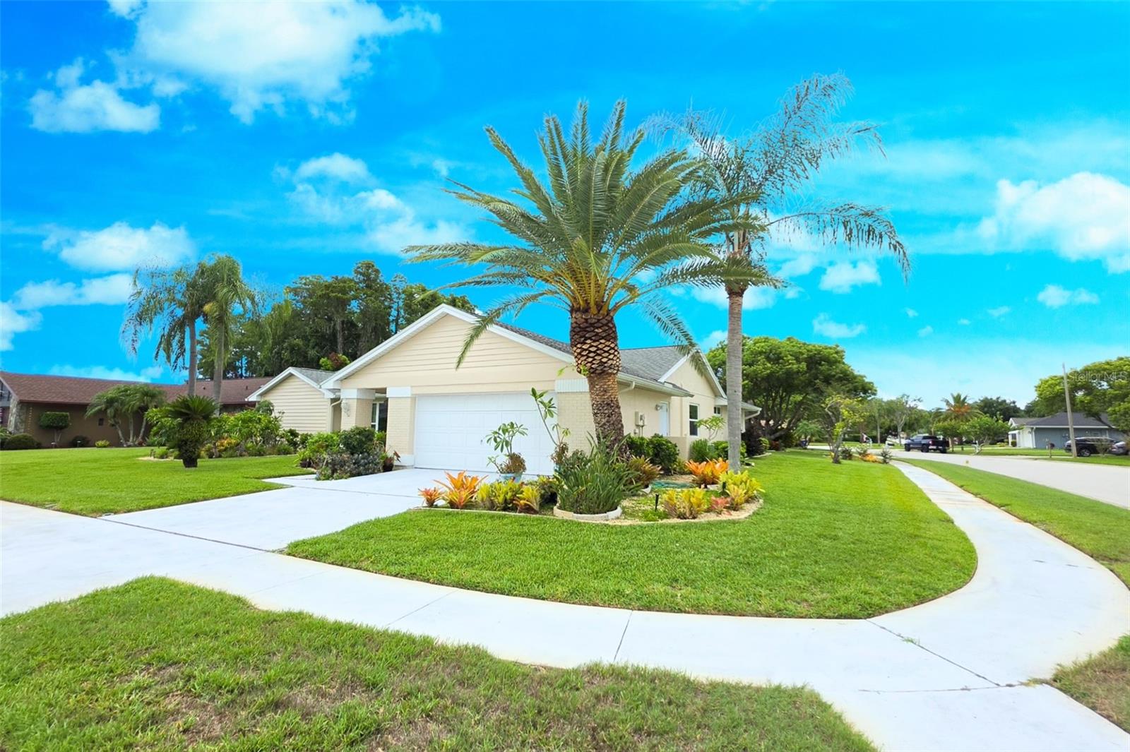 Virtually Staged. ••• SELLER OFFERING A $5,000 CREDIT TOWARD BUYER'S CLOSING COSTS & PREPAIDS - keeping more cash in your pocket for cosmetic updates and personal touches after closing! •••

Welcome to one of the most meticulously maintained homes in Fairway Springs, where EXCEPTIONAL CURB APPEAL immediately sets it apart! Thoughtful updates & pride of ownership (from the ORIGINAL OWNER who had the home built) shine from the moment you arrive. 

Situated on a HUGE CORNER LOT, this beautiful 3-bedroom, 2-bath, 2-car garage home is surrounded by LUSH TROPICAL LANDSCAPING featuring mature palms, vibrant colors, manicured hedges, decorative stone accents & beautifully maintained planting beds that create an unforgettable first impression.

Major exterior improvements have already been completed for you, including a FRESHLY PAINTED EXTERIOR, a newly repainted screened lanai (including the floor), BRAND NEW PATIO SCREENS & newer HURRICANE IMPACT WINDOWS & GLASS SLIDING DOORS (a premium upgrade valued at $30,000) that offers peace of mind & energy efficiency.

Inside, you'll find a SPACIOUS and VERSITILE FLOOR PLAN with tall ceilings designed for both everyday living & entertaining. The OPEN-CONCEPT kitchen, dinette & family room creates the heart of the home, highlighted by a cozy wood-burning fireplace with brick floor-to-ceiling mantle & built in shelving.

The UPDATED KITCHEN was designed with both beauty & functionality in mind, featuring granite countertops, breakfast bar, glass tile backsplash, stainless steel appliances, soft-close cabinetry with modern hardware, a corner Lazy Susan, updated electrical outlets & abundant storage. The kitchen also features a PASS-THROUGH WINDOW to the patio - ideal for entertaining guests on the patio.

A separate formal living room & dining room offers additional gathering spaces, while oversized windows fill the home with ABUNDANT NATURAL LIGHT.

Beautiful LUXURIOUS WHITE PORCELAIN TILE flows throughout the living areas, creating a clean, modern look that's both stylish and easy to maintain.

The owner's suite  was expanded (by the builder) with a two-foot extension, creating a larger bedroom, an OVERSIZED WALK-IN CLOSET, a Makeup/Vanity area, separate dual sinks, skylight and a SPACIOUS SPA-INSPIRED SHOWER featuring dual shower heads and a built-in bench.

The opposite side of the home features two additional bedrooms with double door closets & an UPDATED HALL BATHROOM with a new vanity, granite countertop & fixtures.

The large interior laundry room (adjacent to garage entrance) features a stackable washer & dryer, laundry sink, extra shelving & additional storage cabinetry.

This is the kind of home buyers wait for - beautifully maintained, loaded with meaningful upgrades, and offering the perfect opportunity to add your own finishing touches while using the seller's generous $5,000 CREDIT.

The Community Pool and Pool Deck just received a full renovation and is now open to residents.

Schedule your private showing today before someone else calls this Fairway Springs gem "Home!"