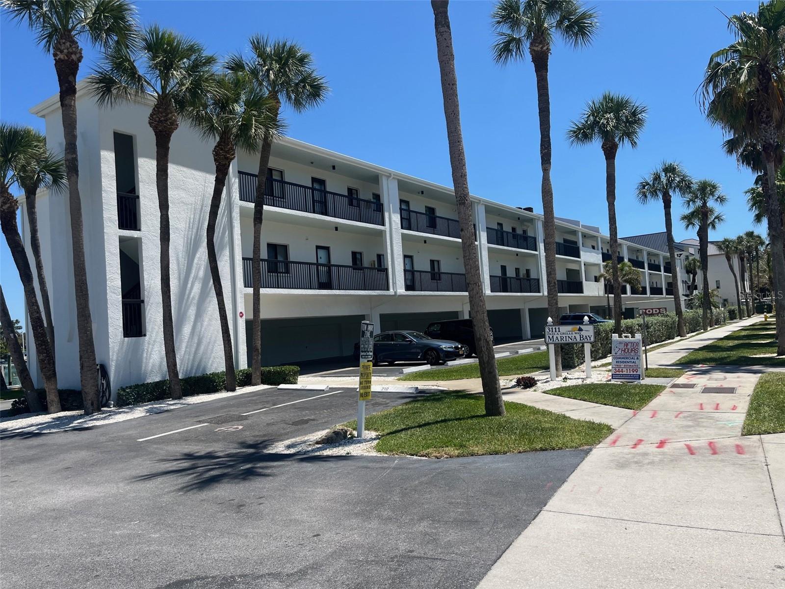 One or more photo(s) has been virtually staged. Sun-drenched end unit with prime waterfront views! This elevated residence features a seamless open floor plan overlooking your private boat slip. Enjoy modern tile flooring throughout, beautifully upgraded walk-in showers, and the convenience of inside laundry. Resort-style living at its best with a heated pool, private beach access, three assigned parking spaces, and a garage.
