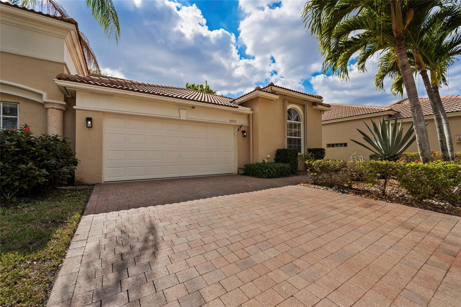 Refined 2-bedroom, 2-bath villa with den located in Palm Beach County, 24/7 guard-gated enclave of Andros Isle. Privately positioned on a quiet cul-de-sac, this semi-attached residence offers a tranquil setting with a fenced backyard and newly refreshed, manicured landscaping. The interior features hard flooring throughout (tile and premium laminate) and a thoughtfully open kitchen appointed with granite countertops, and stainless-steel appliances. The spacious primary suite is complemented by generous closet space and an elegant bath featuring a Roman soaking tub, dual vanities, and elevated finishes. A covered and screened patio provides an ideal extension of the living space, perfect for refined outdoor enjoyment. Additional enhancements include accordion storm shutters and a high-efficiency A/C system. Pet-friendly community. Community association offers exceptional convenience, including professional landscaping and irrigation, 24/7 manned security with in-home monitoring, CATV with high-speed internet and Wi-Fi, exterior painting, and roof pressure cleaning. Residents enjoy a resort-style clubhouse with heated pool and spa, fitness center, sauna, and game rooms, as well as private resident access to Publix via a dedicated roadway.