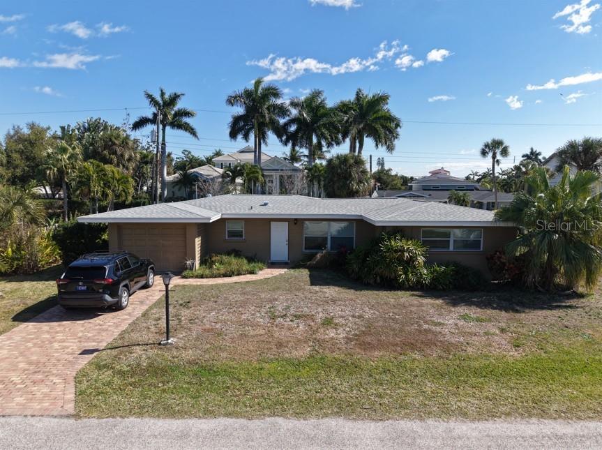 Just a half mile from the world famous Siesta Key Beach, this charming mid century ranch sits quietly tucked within a peaceful, private neighborhood on the mainland. Offering an effortless coastal lifestyle, this beautifully cared for 2 bedroom, 2 bath home features an open layout, a bright and expansive air conditioned sunroom, and a 1 car garage. It’s being offered turnkey furnished, making it an ideal choice for a full time residence, a vacation retreat, or a strong investment opportunity.

With 1,388 square feet of cooled living space plus an additional 232-square foot laundry and utility room, the home feels spacious and inviting. The large glass enclosed Florida room is a standout feature, filled with natural light from oversized windows and overlooking a tranquil, thoughtfully landscaped backyard. Recent improvements include a 2023 roof, updated windows, a newer septic system and lift station, upgraded electrical service, polished terrazzo flooring throughout, and a paver driveway. The effective year built is 1997, reflecting the extensive updates.

Surrounded by multi-million-dollar properties and located less than a mile from the vibrant shops and restaurants of Gulf Gate, this home offers the perfect blend of privacy, convenience, and coastal living. Watersports, dining, and the soft white sands of Siesta Key Beach are all just moments away. Come experience the lifestyle this special property offers.