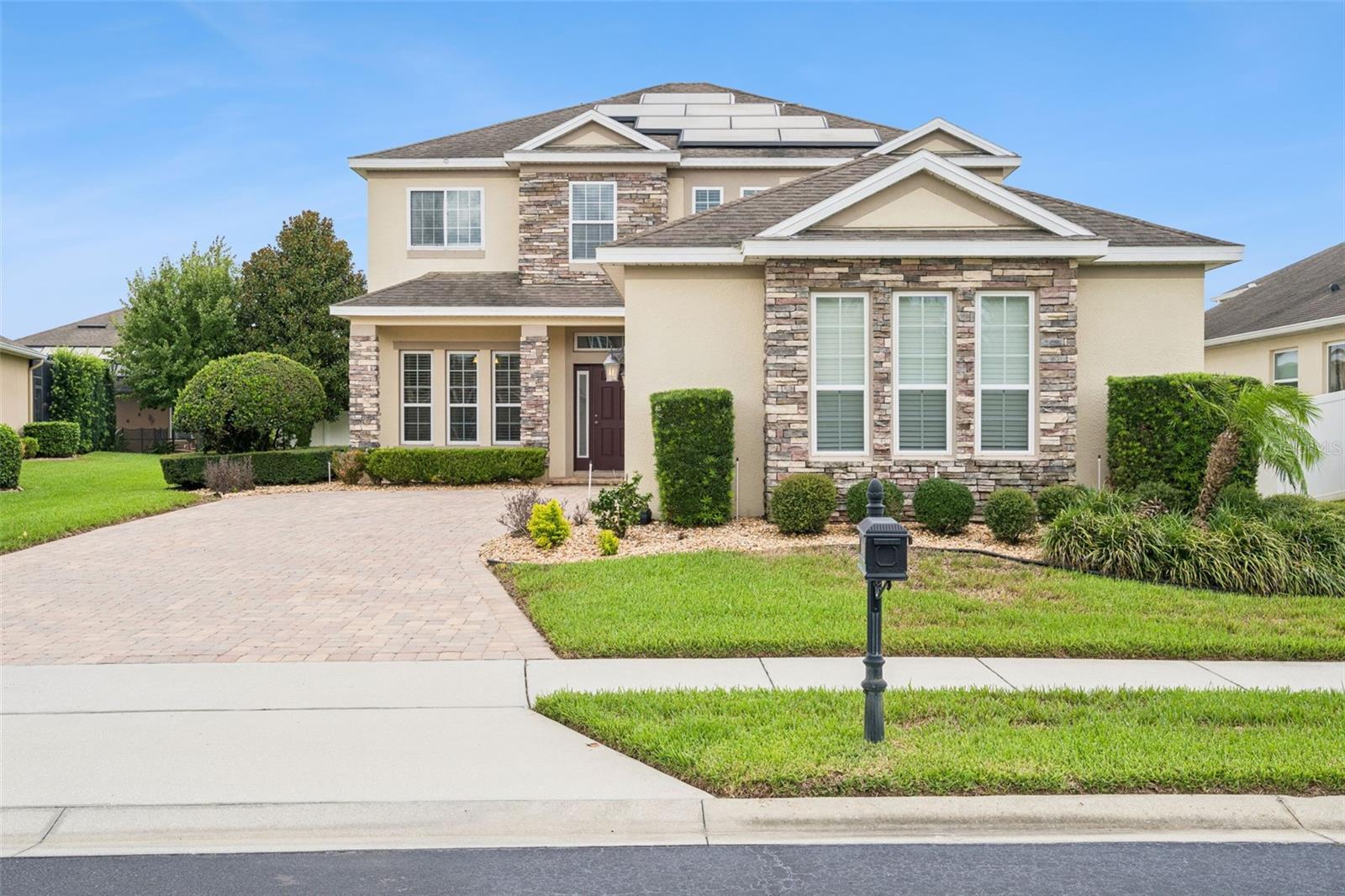 Welcome to this beautifully maintained 4-bedroom, 3-bathroom home in the highly desirable Reserve at Carriage Pointe community! This spacious two-story home features an open-concept floor plan, a well-appointed kitchen overlooking the main living area, and a three-car garage. Step outside to your private screened lanai, where you'll find a gas-heated pool, spa, and fully equipped outdoor kitchen—perfect for year-round entertaining and relaxing. The home is also equipped with solar panels, providing energy efficiency and the potential for lower utility costs, as well as a Tesla charging station in the 3-car garage for added convenience. Ideally located near shopping, dining, major highways, and top-rated schools, this exceptional home offers the perfect blend of comfort, style, and modern amenities.