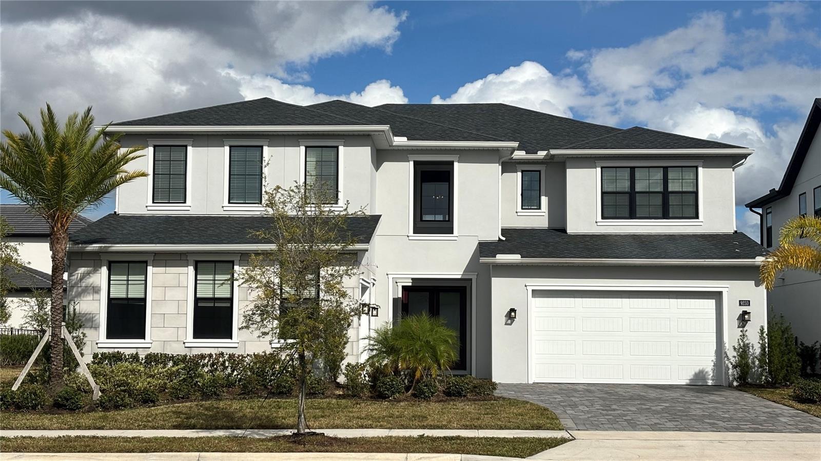Welcome to 9233 Santorini Drive, a stunning move-in ready luxury residence in the Exclusive gated community of Laurel Pointe at Lake Nona, one of Central Florida's most desirable master-planned communities. Built in 2024, this exceptional two-story home perfectly combines Elegant design, luxury finishes, and modern comfort.

A welcoming covered front porch and impressive double-door entry lead into a breathtaking two-story foyer that opens to a formal dining room and an expansive great room filled with natural light. Large sliding glass doors connect the interior living spaces to a spacious covered lanai overlooking peaceful pond views, creating the perfect setting for entertaining or simply relaxing.

The gourmet chef's kitchen is thoughtfully designed with an oversized center island, elegant stone countertops, premium stainless steel appliances, abundant cabinetry, generous workspace, a walk-in pantry, and a butler's pantry that seamlessly connects to the formal dining room.

The luxurious primary suite, conveniently located on the main floor, offers dual walk-in closets and a spa-inspired bathroom featuring dual vanities, a soaking tub, a spacious walk-in shower, and a private water closet. Upstairs, spacious secondary bedrooms surround a versatile loft, while a private den/home office provides an ideal space for remote work or study.

Luxury continues throughout the home with contemporary architecture, wood flooring throughout the main living areas, modern lighting, soaring ceilings, open-concept living spaces, a centrally located laundry room, and a spacious three-car attached garage.

Property Highlights: 5 Bedrooms + Private Den/Home Office, 4.5 Bathrooms, Three-Car Garage, Grand Two-Story Foyer, Open-Concept Floor Plan, Gourmet Kitchen with Oversized Island, Stone Countertops, Stainless Steel Appliances, Walk-In Pantry & Butler's Pantry, Luxurious Main-Level Primary Suite, Spacious Loft, Wood Flooring Throughout Main Living Areas, Covered Lanai with Pond Views, Built in 2024

Residents of Laurel Pointe enjoy an exceptional lifestyle with access to resort-style amenities, including community pools, parks, playgrounds, scenic walking and biking trails, beautifully maintained green spaces, and the wellness-focused lifestyle that has made Lake Nona nationally recognized for innovation, healthcare, technology, and luxury living.

Perfectly located just minutes from Lake Nona Town Center, Orlando International Airport, major highways, premier shopping, fine dining, top-rated Orange County schools, world-class healthcare facilities, universities, and Orlando's famous attractions, this home offers both everyday convenience and long-term investment value.

9233 Santorini Drive is more than a luxury home—it's an opportunity to experience an extraordinary lifestyle in one of Florida's most beautiful communities. Schedule your private tour today and discover why this exceptional residence is the perfect place to call home.