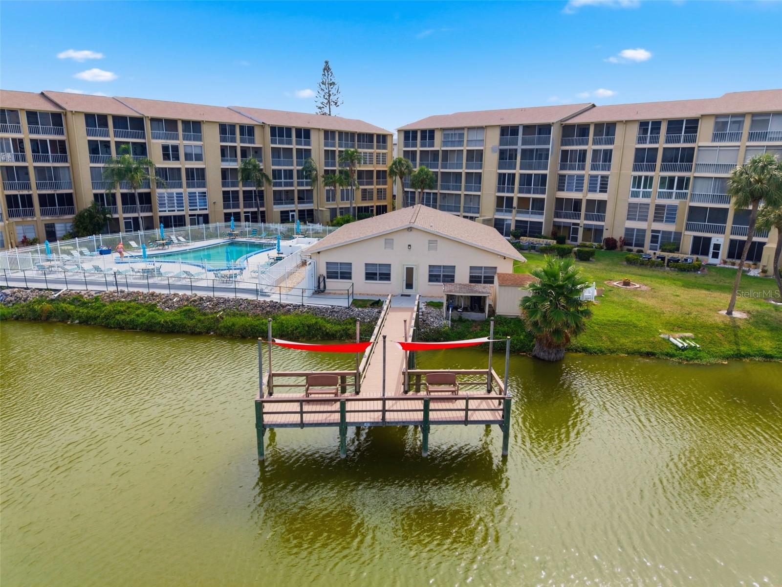 Welcome to easy Florida living in the sought-after 55+ community of Bayshore on the Lake! This beautifully renovated first-floor end-unit condo offers the perfect combination of comfort, convenience, and low-maintenance living - ideal as a seasonal retreat or full-time residence. Inside, you’ll find a bright and inviting 2-bedroom, 2-bath split layout featuring luxury vinyl flooring throughout and a spacious open-concept living and dining area designed for entertaining and everyday comfort. The primary bedroom features a spacious closet with a separate dressing or vanity area. The enclosed lanai, accessed from the primary bedroom and living room, adds valuable bonus space, perfect for relaxing with morning coffee or unwinding while enjoying views of nature year-round. Even better, the assigned parking space is conveniently located directly outside the front door. Residents of Bayshore on the Lake enjoy a relaxed lakefront lifestyle with community amenities including a pool and spa, BBQ grills, shuffleboard courts, a fishing pier over a 30-acre lake, and a community clubhouse with a host of activities! You can’t beat being this close to Gulf beaches, Anna Maria Island, shopping, dining, golf, medical facilities, and the best of the Bradenton area. Cable and internet are included in your HOA fee, making it even easier to move right in and start enjoying all that Bayshore on the Lake has to offer. Whether you're escaping the cold winters or simplifying your lifestyle, this hidden gem offers an exceptional opportunity to enjoy the Florida lifestyle at an affordable price point.