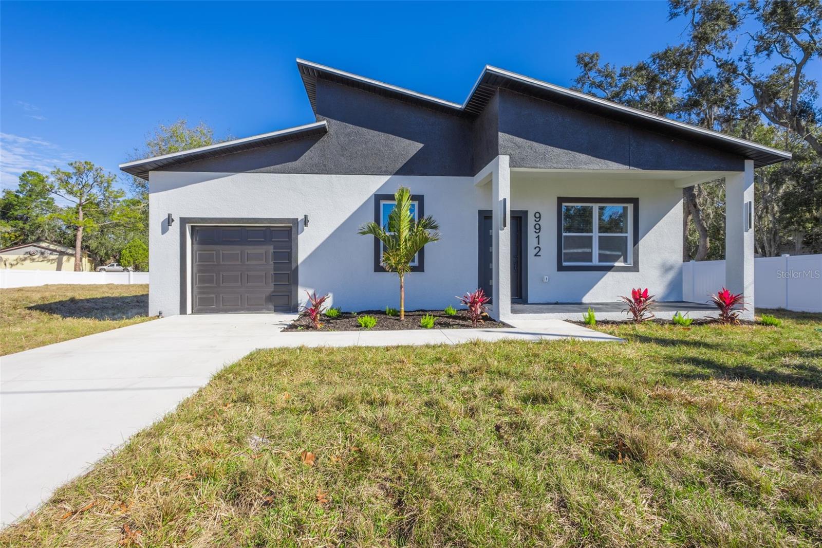 Welcome to 9912 Golden Loop, a newly constructed custom 3-bedroom, 2-bath home with a 1-car garage situated on a spacious lot in desirable New Port Richey. Designed with modern comfort and style in mind, the interior features quartz countertops, a breakfast island, crown molding, 42” white cabinetry, recessed lighting, and a spacious kitchen that includes all Samsung appliances. Beautiful wood-look tile flooring flows throughout the home, complemented by modern remote-control ceiling fans. The private primary suite includes sliding barn doors leading to dual closets with built-in shelving and a luxurious bathroom offering a rain shower fixture, soaking tub, and walk-in glass shower. Immaculate secondary bath and generous storage throughout. The garage is finished with durable epoxy flooring, and the property offers no backyard neighbors for added privacy. Additional upgrades include a tankless water heater and a private well, meaning no water bill for the future owner. This newly constructed home is equipped with hurricane-proof impact windows, ensuring enhanced safety and peace of mind during severe weather. These windows not only provide superior protection but also improve energy efficiency and reduce outside noise, making the home both safe and comfortable. Embrace country living without sacrificing convenience, just 30 minutes from Tampa International Airport, 30 minutes to the area's beautiful Gulf beaches, and 15 minutes to popular waterfront dining. Plus, you're only minutes away from a wide variety of shopping, restaurants, and everyday amenities, offering the perfect balance of accessibility and Florida lifestyle living. Be the first to live in the gorgeous brand-new home! First, last and security deposit required at the time of lease. Schedule your showing today!