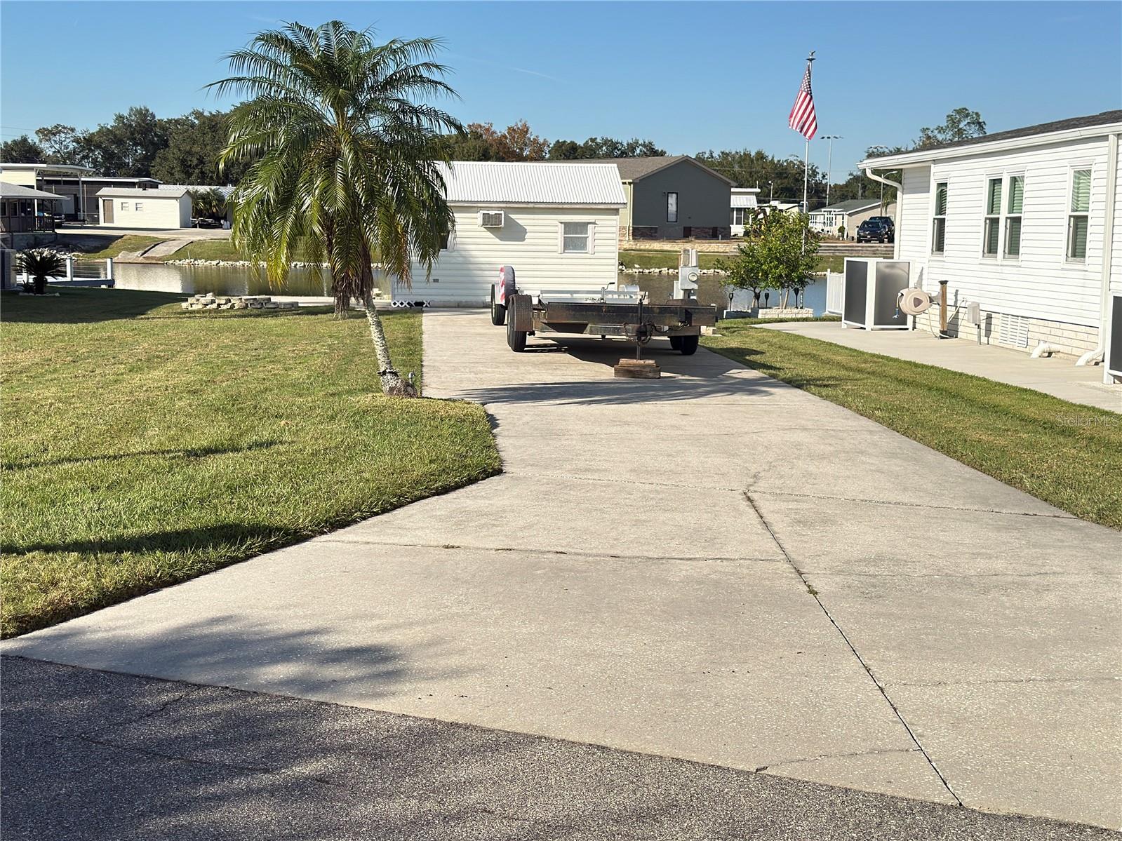 Discover an outstanding waterfront opportunity in Phase 3 of Mount Olive Shores — a premier, deed-restricted Class A motorhome community designed for those who appreciate both comfort and connection.

This exceptional canal-front lot delivers beautiful water views and features a durable concrete slab engineered to accommodate any size Class A motorhome with ease. Full public utility hookups, including 50-AMP service, are already in place, providing immediate convenience. There is also ample room to add a manufactured home and RV port, giving you flexibility to expand and customize your space.

Enhancing the property is a fully finished shed with power — ideal for secure storage, a workshop, or potential additional living space.

Beyond the lot itself, the community lifestyle is equally impressive. Located just 3.5 miles from I-4, you’ll have quick access to shopping centers, major medical facilities, and both Tampa and Orlando International Airports — all less than an hour away.

Residents now enjoy a brand-new 5,000-square-foot heated and cooled Community Center designed to elevate everyday living. This dynamic space includes:
 • Full kitchen
 • Regulation-size shuffleboard and pool tables
 • Dart boards and arcade games
 • Dedicated card room and library
 • Vending area
 • Covered BBQ lanai for gatherings

A robust calendar of seasonal events — including Bingo, karaoke nights, potluck dinners, and holiday celebrations — creates consistent opportunities to socialize and build lasting relationships.

Important: As a deed-restricted Class A motorhome community, ownership or lease of a Class A motorhome is required your first year of residency.

This is more than a waterfront lot — it’s a strategic investment in a lifestyle defined by convenience, recreation, and community.