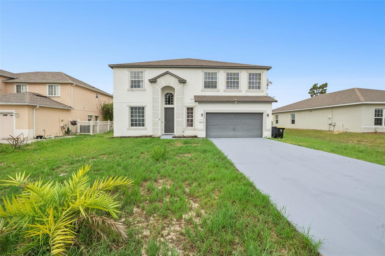 Welcome to 1853 Superior Court, a spacious two-story home in the heart of Poinciana Villages offering over 3,400 square feet of living space on a generous .27-acre lot. With 5 bedrooms, 3 full baths, and a half bath, this home has the room and flexibility your family has been looking for. From the moment you walk in, you'll notice luxury vinyl plank flooring flowing through the main living areas, fresh paint in the formal living and dining rooms, and an open concept kitchen and family room perfect for everyday living. The kitchen features solid surface counters, a breakfast bar, closet pantry, and plenty of cabinet space. The primary suite is on the main floor and includes a walk-in closet and en-suite bath with dual sinks, a garden tub, and a separate shower. Upstairs you'll find three additional bedrooms, two full baths, a large bonus room, and a bright open loft perfect for a playroom, office, or second living area. The second floor also features a large second master en suite with a private sink and an attached bathroom. Step outside onto the rare open-air deck for a peaceful backyard view or relax on the main floor screened lanai for morning coffee or evening gatherings. Major updates have already done, including a new roof (2022), new upstairs AC (2023), new staircase and assumable solar system (2024), and a brand-new water heater (2025). There is also an assumable VA mortgage, offering a valuable financing opportunity for eligible buyers. The home includes an attached two-car garage and sits in Flood Zone X, so no flood insurance is required. Poinciana Villages has a low HOA of just $90/month, which includes cable, internet, pool access, a fitness center, recreational facilities, and community events. The home is within walking distance of Lake Marion Creek Middle School, and you'll be close to parks, medical facilities, US 17, I-4, and the Florida Turnpike, with Orlando's theme parks just a short drive away.