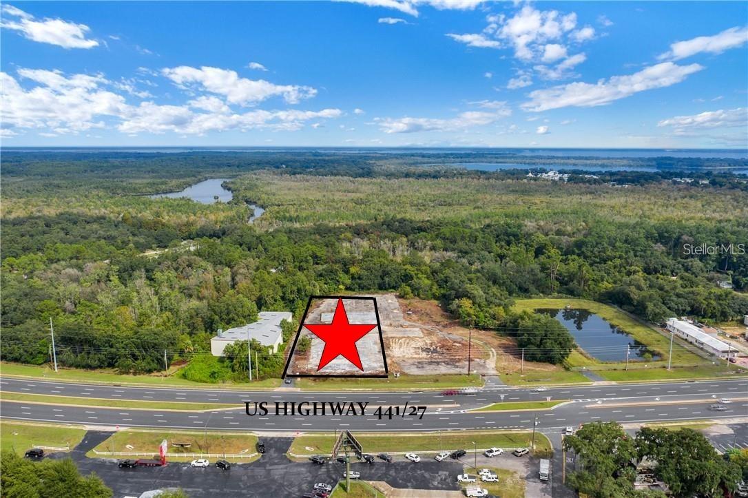 Positioned in one of Central Florida’s fastest-growing corridors, this 1.27-acre commercial site in the City of Fruitland Park presents an exceptional opportunity for investors, developers, or end users looking to capitalize on rapid area growth and high visibility.

Boasting approximately 147 feet of frontage along heavily traveled US Highway 441/27, this property offers outstanding exposure for a wide range of commercial uses—ideal for businesses seeking strong traffic counts and maximum visibility. Large concrete pad onsite with shared driveway easement. Located in an X Flood zone. 

Zoned Mixed Use (Warehouse, C-2 General Commercial & CPUD) with a Commercial Future Land Use designation, the property supports a variety of potential uses including retail, service-based businesses, storage, or redevelopment projects—making it highly attractive for both immediate development and long-term investment.

Located within Fruitland Park city limits, the site benefits from available city utilities and existing electrical service, offering a streamlined path to development.

Strategically situated adjacent to Lake Griffin State Park and positioned between Leesburg and only 4 miles to The Villages—one of the fastest-growing master-planned communities in the nation—this location benefits from strong demographics, increasing traffic counts, and sustained economic expansion.

Convenient access to major transportation routes including the Florida Turnpike, I-75, US 27, and CR 466 further enhances connectivity. The property is approximately 30 miles to Ocala, one hour to Orlando, and within two hours of Florida’s Gulf and Atlantic coastlines.

This is a rare opportunity to secure a high-visibility commercial site in a thriving market with a motivated seller ready to make a deal and is open to trades—ideal for buyers seeking flexibility & growth. Call today for more information.