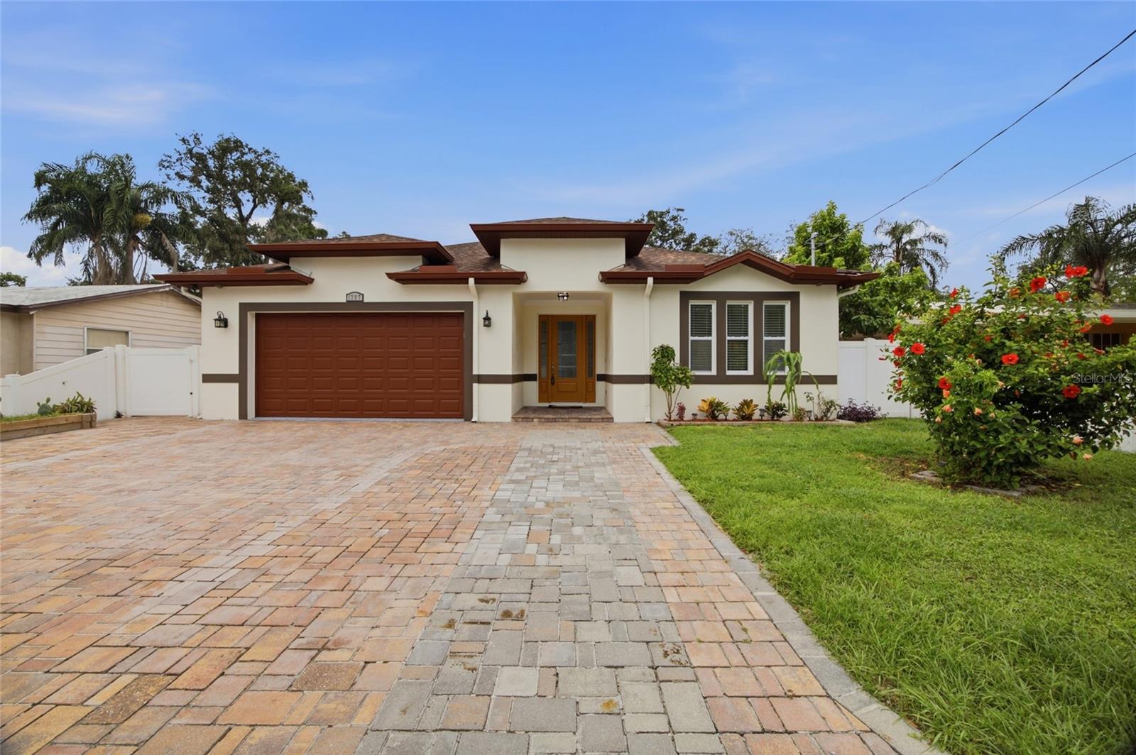 MOVE IN READY and beautifully maintained, this 2019-built home offers 1,991 heated square feet with 4 bedrooms, 2 bathrooms, and a desirable open floor plan designed for comfortable living and effortless entertaining. Step inside to discover wood-look ceramic tile flooring throughout, providing durability, style, and easy maintenance. The heart of the home is the chef-inspired kitchen, featuring 42-inch cabinets, granite countertops, stainless steel appliances, a large island, and abundant cabinet and counter space. The spacious primary suite serves as a private retreat with a walk-in closet featuring custom built-ins. The en-suite bathroom offers dual vanities, a walk-in shower, and a soaking tub, creating a relaxing spa-like experience.  Additional highlights include a dedicated laundry room with built-in cabinetry, and the washer and dryer convey with the home. The oversized two-car garage features a durable epoxy-coated floor, while the paver driveway enhances the home's curb appeal. Enjoy Florida living year-round from the covered patio with finished flooring, which leads to a beautiful wood deck overlooking the backyard. Outdoor amenities also include a storage shed, a low-maintenance area of artificial turf, and two mature avocado trees currently producing fruit. NO HOA! Conveniently located with easy access to I-4, I-275, and the Selmon Expressway, this home is just minutes from Downtown Tampa, Ybor City, Armature Works, the Water Street and Channelside District, shopping, dining, entertainment, and major employers. Tampa International Airport is less than 20 minutes away, making commuting and travel exceptionally convenient. If you're looking for a move-in ready home that combines modern finishes, functional living spaces, outstanding outdoor features, and a central Tampa location, this property is one you won't want to miss. Disclaimer: All information provided is believed to be accurate but is not guaranteed. Seller has a recent appraisal available that supports the current list price. A copy may be provided upon request. Buyer and/or Buyer's Agent are responsible for independently verifying all information, including but not limited to room dimensions, square footage, lot size, measurements, zoning, schools, and any other information deemed material to the Buyer's decision.