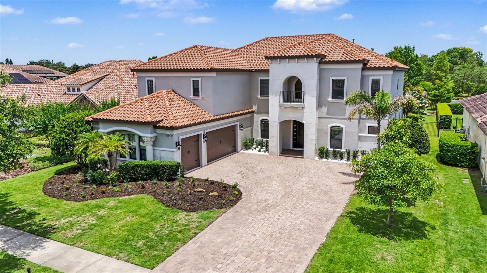 An exceptional opportunity awaits in Old Memorial Estates, a premier gated enclave known for its privacy, prestige, and beautifully appointed residences. Set on nearly half an acre in one of Tampa’s most sought-after luxury communities, this beautifully maintained residence offers privacy, space, and refined Florida living just minutes from top-rated schools, premier golf, dining, shopping, and Tampa International Airport. Freshly painted inside and out (2026), the home delivers a crisp, move-in-ready feel with thoughtful updates throughout. A 3-car side-load garage enhances the curb appeal, complemented by natural stone accents and lush landscaping, setting the tone for the elegance found within. Inside, you’re greeted by soaring volume ceilings and a light-filled, open layout designed for both everyday comfort and upscale entertaining. The heart of the home features double kitchen islands, creating an exceptional space for gathering, cooking, and hosting with ease. The living areas flow seamlessly to a large covered patio, extending your living space outdoors and embracing true Florida indoor-outdoor living. The primary suite and a secondary suite are conveniently located on the first floor, offering flexibility for guests or multigenerational living. Upstairs, you’ll find four additional bedrooms, a versatile loft retreat, a kitchenette, and a dedicated home theater room, creating an expansive second level perfect for entertainment and relaxation. The backyard is a true blank canvas, ready to accommodate a custom pool and outdoor oasis tailored to your vision. Schedule your private tour today and experience the elegance, accessibility, and lifestyle that make Old Memorial Estates one of Tampa’s premier gated communities.