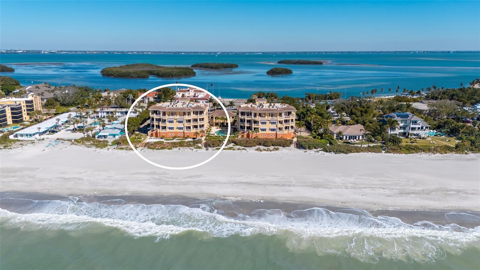 Spectacular Gulf of Mexico views define this exceptional three-bedroom, three-and-a-half-bath residence that lives like a single-family home. A large wraparound terrace with a built-in grill offers seamless indoor-outdoor living, and private steps leading directly to the sandy beach – perfect for sunset entertaining or morning walks along the shore. Enter the home through a private elevator into a formal foyer with double door entry into the residence. The gracious living room is framed by expansive windows showcasing endless water views and exceptional sunsets flowing effortlessly to a built-in wet bar complete with wine refrigerator, ice maker, and a dedicated desk area—ideal for entertaining or casual work-from-home moments. A formal dining room with elegant ceiling detail makes hosting a dinner party a treat. Plantation shutters throughout the residence add a coastal and private touch. The gourmet kitchen is designed for both function and style, offering a large island for gathering, side-by-side Sub-Zero refrigerator and freezer, Wolf gas cooktop, Wolf oven with warming drawer, generous pantry, and a cozy desk area for browsing favorite recipes. A large center island and charming breakfast nook are the perfect spots for morning coffee or casual meals. Adjacent to the kitchen, the inviting keeping room opens to a private east-facing terrace with beautiful sunrise and views of Sarasota Bay. The expansive owner’s suite is a true retreat, featuring its own breakfast bar with sink and refrigerator for enjoying morning coffee while overlooking the Gulf. Two oversized, custom-built walk-in closets provide exceptional storage. The spa-inspired bath includes double vanities, a glass-enclosed shower, a private water closet with bidet, and refined finishes throughout. Two en-suite guest bedrooms with large custom-built closets open onto a private terrace with views of Sarasota Bay, ensuring comfort and privacy for family and guests alike. This rare beachfront residence combines luxury, privacy, and the ease of coastal living, all with breathtaking views and thoughtfully designed spaces for everyday enjoyment and elegant entertainment. Residents of La Firenza enjoy a boutique, gated setting with private beach access, a heated beachfront pool and spa, fitness facilities and secure garage parking.