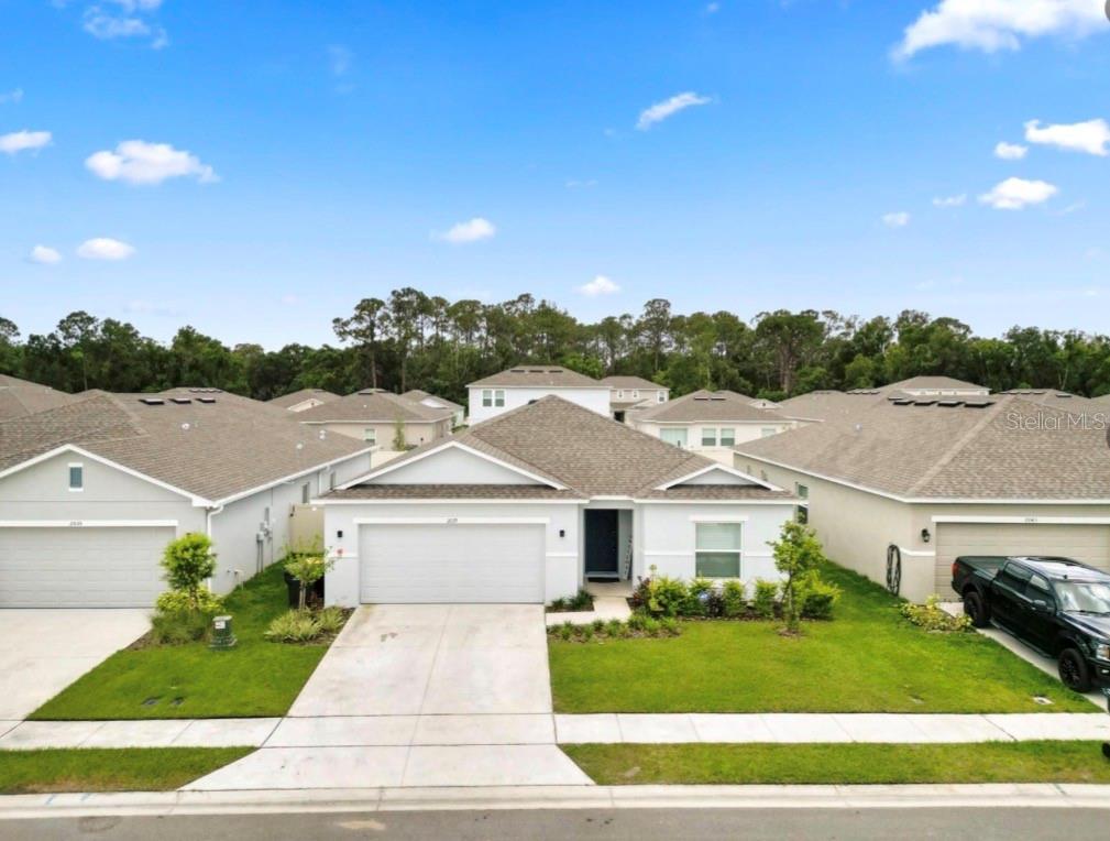 Beautiful 4BR/2BA Taylor Morrison Cypress Model featuring an open floor plan, quartz countertops, stainless-steel appliances, tile flooring in main living areas, split-bedroom layout, screened lanai, water softener, and spacious primary suite. Located in a charming community with sidewalks and a butterfly garden. Move-in ready!