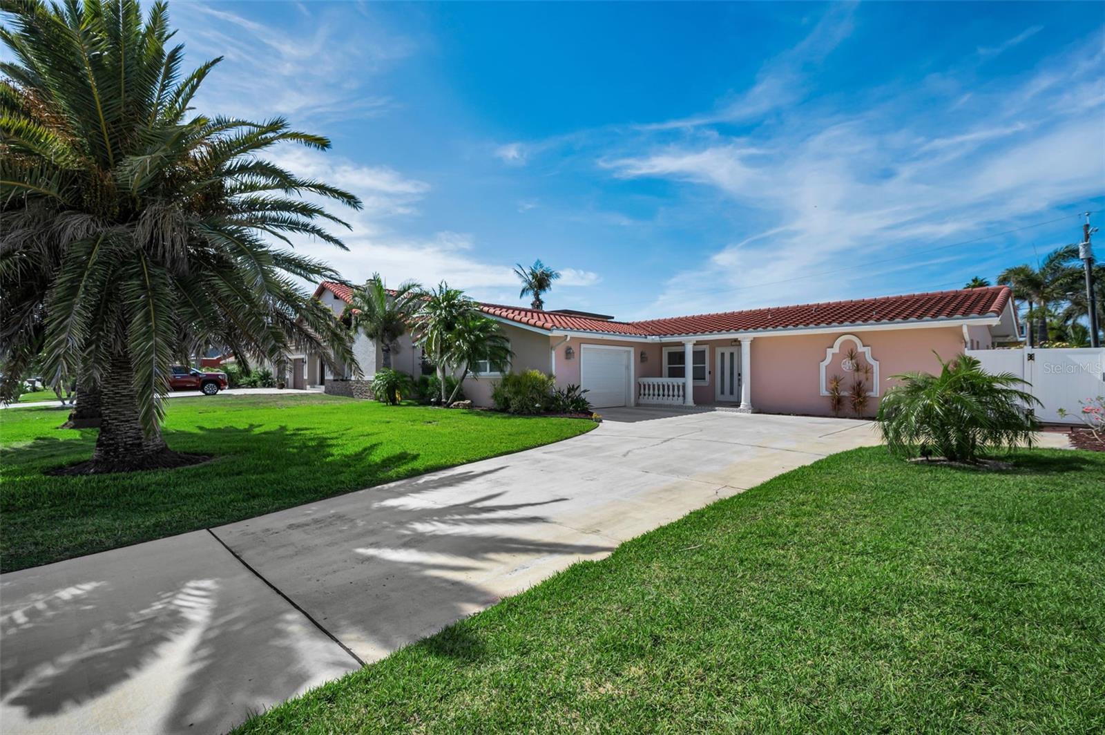 **Coastal luxury meets peaceful beach living** in this beautifully updated 3-bedroom, 2-bath residence with a heated resort-style pool and oversized garage, located just two blocks from the Gulf of Mexico in the exclusive community of Belleair Beach.

Unlike many nearby beach towns filled with vacation rentals and tourist traffic, Belleair Beach offers a tranquil, residential lifestyle. With only one public beach access and no short-term rentals permitted, residents enjoy uncrowded beaches, quiet streets, and a true neighborhood atmosphere. Deeded private beach access and a community boat ramp provide effortless access to the Intracoastal Waterway, making it easy to enjoy boating, fishing, paddleboarding, and spectacular Gulf sunsets.

Designed for entertaining, the spacious living and dining rooms flow seamlessly together and feature a stylish dry bar with additional seating. The adjoining family room showcases an electric fireplace with custom built-ins and opens to the beautifully remodeled kitchen, creating an inviting space for everyday living and large gatherings alike.

Renovated in 2025, the chef-inspired kitchen features white Shaker cabinetry, premium Corian countertops, stainless steel appliances, an induction cooktop, and abundant workspace. Walls of glass overlook the private backyard retreat, where a heated resort-style pool with an expansive sun shelf, waterfall feature, and built-in stools creates the perfect setting for year-round outdoor living. The fully fenced yard offers exceptional privacy for relaxing or entertaining.

The split-bedroom floor plan provides privacy for the primary suite, complete with new luxury vinyl plank flooring, a walk-in closet, and an ensuite bath featuring a jetted tub and separate shower. A spacious sunroom with portable air conditioning offers flexible space for a home office, fitness room, hobby room, or additional living area.

**Recent Improvements Include:**
• Remodeled Kitchen (2025)
• Stainless Steel Appliances (2025)
• Fresh Interior Paint (2025)
• New Interior Doors (2025)
• Water Heater (2025)
• Pool Pump (2025)
• Washer (2025)
• Dryer (2025)
• Concrete Tile Roof (2016)

If you've been searching for an authentic Florida beach lifestyle without the congestion and constant turnover of neighboring tourist destinations, this exceptional Belleair Beach home delivers the perfect combination of modern updates, resort-style amenities, and an unmatched coastal setting just minutes from Clearwater Beach, a variety of dining options, shopping, and entertainment.