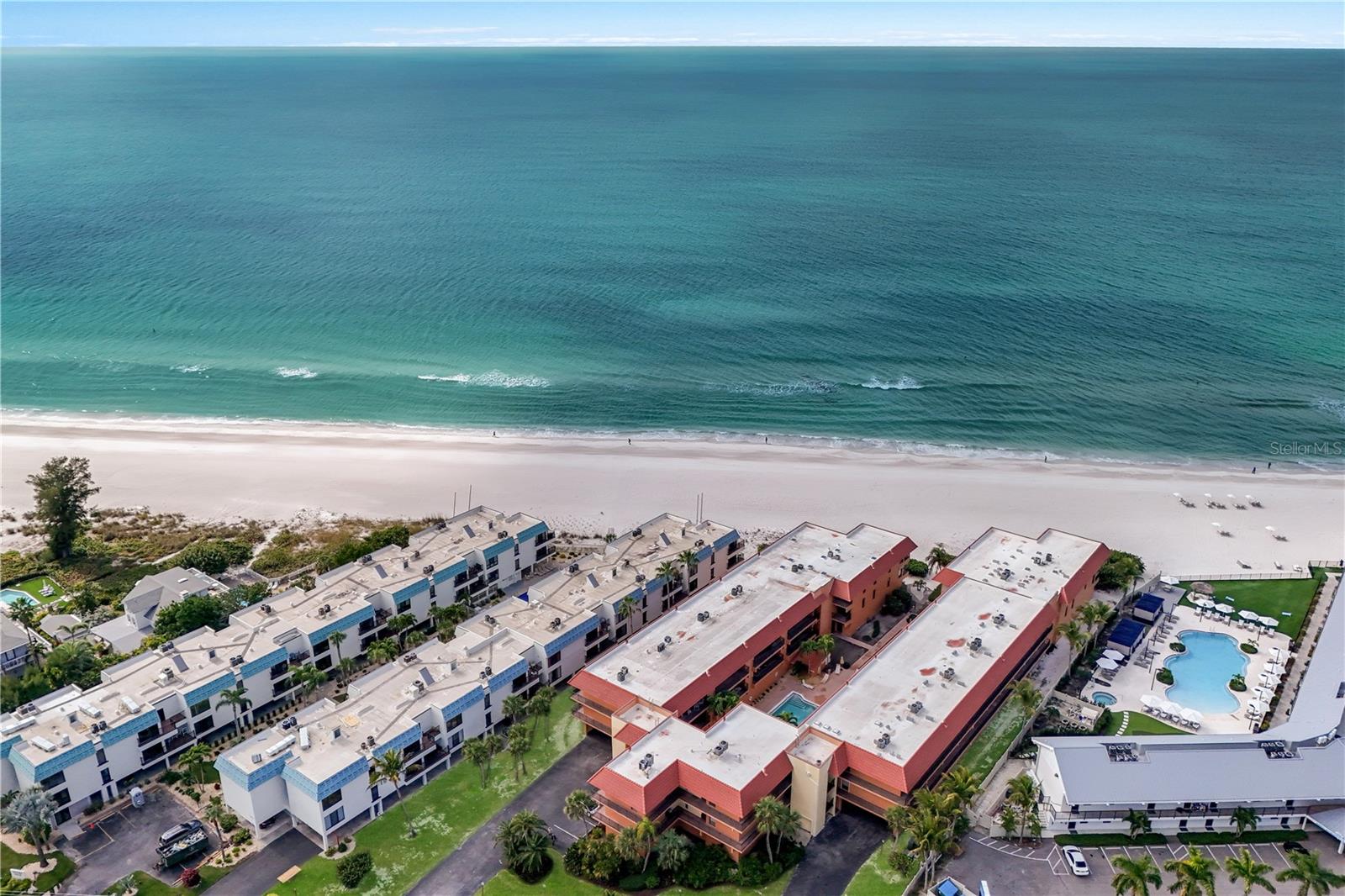 Set within the beachfront enclave of Playa Encantada, this beautifully maintained two-bedroom, two-bath residence offers an effortless coastal lifestyle just steps from the sand and the island trolley — placing the area's finest shops, restaurants, and attractions within easy reach.
Inside, an open and light-filled layout creates an inviting sense of space. The kitchen is appointed with granite countertops, stainless steel appliances, and generous cabinetry, while the living and dining areas flow seamlessly onto a private balcony overlooking the heated pool — an ideal setting to take in the Gulf breezes and glimpses of the water beyond. Both bedrooms are generously sized, with the primary suite featuring a private en-suite bath.
Residents enjoy a thoughtful collection of resort-style amenities, including a heated pool, tennis courts, shuffleboard, and private beach access. A flexible two-week minimum rental policy further enhances its appeal, offering an exceptional opportunity as a seasonal retreat or income-producing investment.