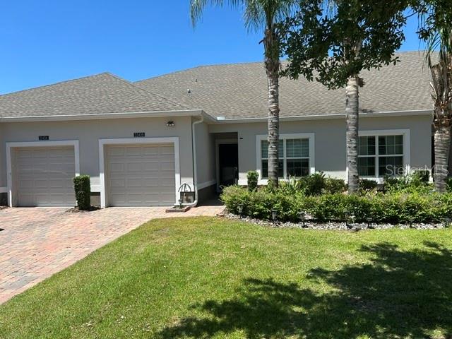 AMAZING PRICE FOR THIS LEVEL OF UPGRADES AND FINISHES!  LOADED WITH UPGRADES  - ENCLOSED REAR PORCH – NO REAR NEIGHBOR. Spend your free time doing what you enjoy as the HOA in the Villa section handles exterior paint, roof replacement, cable, internet, irrigation and exterior landscape maintenance. Tasteful improvements include GLASS ENCLOSED REAR PORCH with tile flooring and custom blinds, TILE FLOORS IN BOTH BEDROOMS (no carpet anywhere), EVERY APPLIANCE UPGRADED (SAMSUNG REFRIGERATOR and DISHWASHER, BOSCH MICROWAVE, and LG DOUBLE OVEN RANGE (the top oven has never been used), & WASHER & DRYER, and even the GARBAGE DISPOSAL was replaced), CUSTOM LIGHT FIXTURES THROUGHOUT, KEYLESS ENTRY, and a STORM DOOR AT THE FRONT ENTRANCE. The main suite bathroom has been freshly painted and features a CUSTOM PORCELAIN TILE FLOOR, UPGRADED VANITY MIRRORS and LIGHTS, an ELECTRIC BIDET TOILET WITH HEAT AND DRYING OPTIONS and a spa-like SHOWER SYSTEM with BODY SPRAYS. This beautiful villa has neutral light gray TILE flooring throughout, beautiful white kitchen and bathroom cabinets with granite counters, stainless steel appliances, pendant lights and a POT RACK over the breakfast bar. The great room opens to an enclosed porch with windows and an exterior door that offers additional living options. The enclosed porch/bonus room faces north and overlooks a green space and a dry retention area. Bedroom 1 features a CUSTOM CEILING FAN/LIGHT and custom blinds and the main suite features a MURANO BLOWN GLASS LIGHT FIXTURE and custom blinds. Upgraded CUSTOM LIGHT FIXTURES also adorn the foyer, great room and bonus room. Heritage Hills is a 55+ guard gated, full-service community with tennis and pickleball courts, pool, dog park, clubhouse, gym, billiard and card rooms, sauna and a complete schedule of monthly events and activities for residents. Heritage Hills is convenient to grocery shopping, hospitals, the FL Turnpike and all of the specialty shops and restaurants of both downtown Clermont and Downtown Winter Garden just a short drive away. Walk the ample sidewalks within the community, or get a golf cart for quick trips to the many clubhouse amenities and activities.