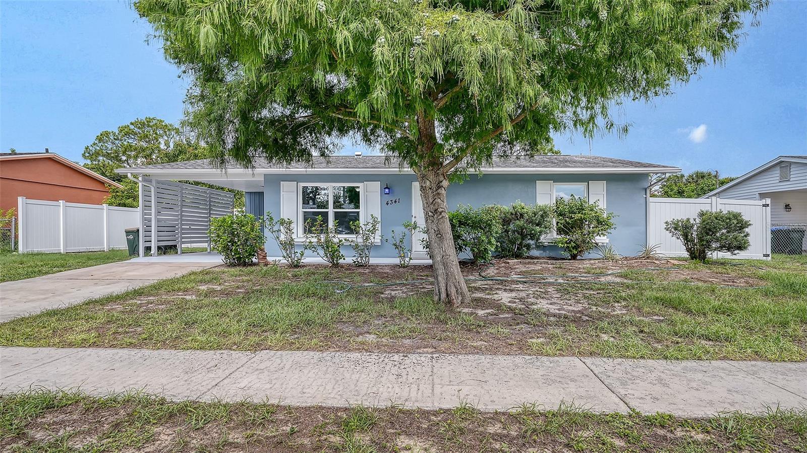 Ready for hassle -free living? This cute-as-a-button home has been lovingly maintained, boasting a variety of fantastic upgrades... the fresh interior and exterior paint to the brand-new LVP flooring in most of the living areas and both bedrooms, Roof 2021, a new hot water heater, newer AC 2019, and a brand-new electrical panel, house replumbed in 2007, All the hard work has already been done for you.  At the heart of the home, the kitchen impresses with Rainforest Granite countertops, quality wood cabinetry, and stainless steel appliances. The updated bathrooms also feature newer toilets, marble vanities, and fixtures. The floor plan offers wonderful versatility, including an enclosed lanai for flexible living space and a dedicated indoor laundry room that's ideal for hobbies or crafting.  Night-shift workers will especially appreciate how perfect the main bedroom is for daytime rest. The property is rounded out by an oversized carport, an incredibly convenient separate storage area, and a fully fenced yard featuring a mature mango tree.  Located on a peaceful, quiet street, this home is absolutely cute as a button. Schedule your tour today!  Minutes away from historic Warm Mineral Springs Park and Kirk Park with a playground, Sports Courts, Picnic Pavilion and Picnic Amenities.