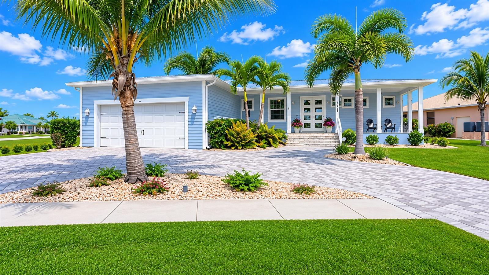 One or more photo(s) has been virtually staged. Experience luxury Florida living in this stunning 3-bedroom plus Den, 2-bath custom-built home perfectly positioned on the 6th tee of the beautiful Saint Andrews South Golf Course in Punta Gorda Isles. Offering breathtaking golf course and water views paired with unforgettable sunset skies, this exceptional property combines elegance, quality construction, and modern smart-home convenience in one extraordinary package.

Built just 8 years ago and situated high and dry with approximately 11 feet of elevation, this meticulously maintained residence features a desirable metal roof, hurricane-rated windows plus shutters for added peace of mind, and no hurricane damage from any storm. From the moment you step inside, you’ll appreciate the airy open-concept design filled with natural light, soaring tray ceilings with crown molding, towering 8-foot doors, recessed lighting, designer 5-inch baseboards, and beautiful porcelain wood-look plank tile throughout. Fresh interior and exterior paint create a clean, modern coastal feel, while expansive sliders seamlessly open to the outdoor living area, perfectly blending indoor and outdoor Florida living.

The chef-inspired kitchen is truly the centerpiece of the home, showcasing custom soft-close cabinetry, granite countertops, energy-efficient stainless steel appliances, tiled backsplash, an oversized entertaining island, and a built-in pull-out pantry designed for both beauty and functionality. Shiplap accent details add warmth, charm, and a custom designer touch throughout the home.

The spacious primary suite offers a relaxing retreat complete with dual comfort-height vanities and a beautifully designed all-tile walk-in shower. Additional bedrooms provide flexibility for guests, family, or a home office.

This home is loaded with premium smart-home upgrades including a portable 50-amp generator with whole-house transfer switch hookup, remote-controlled smart irrigation system, smart switches and outlets throughout, Nest thermostat with phone control, Nest smoke and CO2 alarms, whole-house 3-stage water filtration system, EV/Tesla 60-amp charging station, and outdoor security cameras.

Step outside into your own private resort-style oasis featuring a heated saltwater pool, stunning paver pool deck and driveway, stainless steel cable railing pool enclosure, dramatic jet water arch features, baby barrier fencing, and lush tropical easy-to-maintain landscaping with coconut palms and additional tropical foliage that create the ultimate Florida resort atmosphere. Relax poolside while overlooking the tranquil lake and golf course views and enjoy some of the most spectacular sunsets Punta Gorda has to offer.

Adding even more charm and personality to this exceptional property is the adorable matching neighborhood library house designed to capture the attention of neighbors and guests alike. This delightful feature embraces the spirit of community with the heartwarming message: “Need a book? Take one. Have a book? Leave one.” A truly unique touch that adds warmth, character, and charm to this already extraordinary home.

The oversized 2.5-car garage offers extended 27+ foot depth, pull-down attic access, and built-in storage racks for exceptional storage and convenience.

Located just minutes from downtown Punta Gorda, Fishermen’s Village, waterfront dining, shopping, marinas, parks, and entertainment, this extraordinary home offers luxury, lifestyle, and location all in one.
