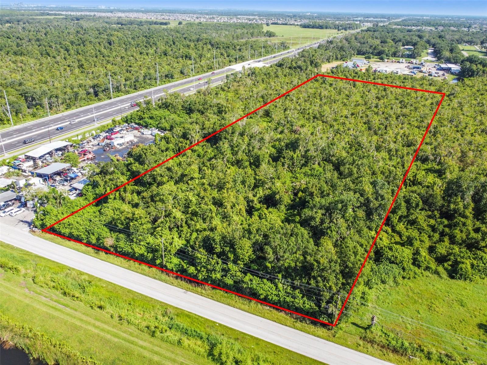This rare ±10-acre offering consists of two adjacent ±5-acre parcels located at 11632 Bill Tucker Rd (Parcel #U-29-31-20-ZZZ-000003-19440.0) and 10502 Bill Tucker Rd (Parcel #U-29-31-20-ZZZ-000003-19430.0). Together, they represent one of the last remaining ±10-acre sites available in this highly sought-after corridor.
The property features exceptional visibility and exposure from US-301, with approximately 330 feet of frontage on Bill Tucker Road, capturing traffic from tens of thousands of drivers daily. This prime location is just 3 miles south of Big Bend Road, home to major retailers such as Sam’s Club, Walmart, Publix, and multiple shopping centers, and 2.5 miles north of US-674 (Sun City Center Blvd), offering additional national retailers and dining options. Interstate 75 is easily accessible within 4 miles, via Exits 246 and 240, providing excellent regional connectivity.
The ±10 acres (433,858 square feet) are surrounded by a dense and rapidly expanding commercial and residential market. Nearby national and regional retailers include: Walmart, Sam’s Club, Publix, ALDI, Chick-fil-A, Sprouts Farmers Market, Texas Roadhouse, Panera Bread, McDonald’s, Walgreens, Tractor Supply Co., Verizon, AT&T, and many more.
The site is also embedded within one of the fastest-growing areas of Hillsborough County, with nearby residential communities such as Cypress Creek, Ayersworth, Valencia Del Sol, Belmont, South Fork, Sereno, Southshore Bay, etc. More than 10,000+ newer single-family & multifamily homes built within the immediate trade area, delivering a very strong, built-in customer-base of tens of thousands of residents just minutes away!