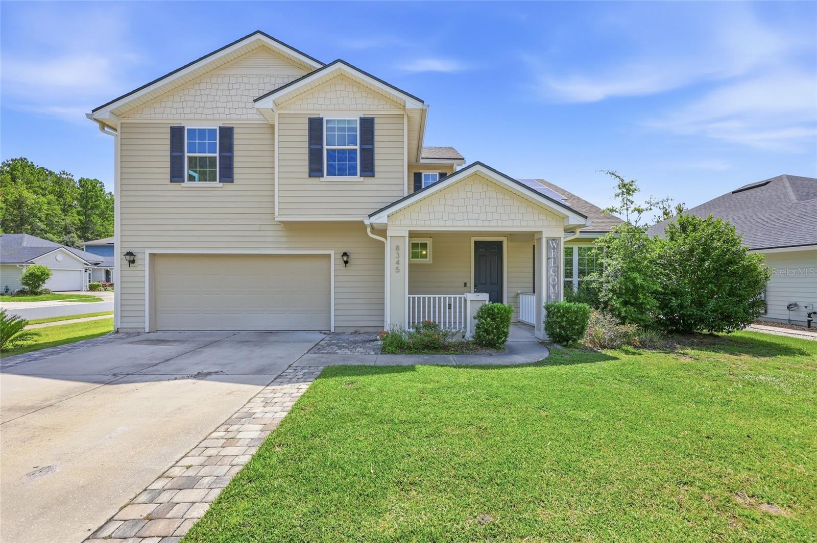Welcome to this spacious and thoughtfully upgraded home on a desirable corner lot overlooking the community pond, where flexible living spaces, quality improvements, and an incredible backyard create exceptional value. Lovingly lived in and enjoyed by its current owners, this home offers numerous upgrades beyond many others in the neighborhood while providing the perfect opportunity for a new owner to make it their own. From the moment you arrive, you'll appreciate the inviting front porch, oversized driveway, and extended two car garage with additional space ideal for a workshop, extra storage, or even parking a third vehicle, along with convenient access to the backyard. Step inside to find rich wood flooring flowing throughout the main living areas, tile in the bathrooms, and comfortable carpet in the bedrooms. Just off the entry, French doors lead to a versatile flex room that is perfect for a home office, playroom, or fifth bedroom. Nearby, a convenient half bath with a pedestal sink and coat closet is ideal for guests. The open concept floor plan is designed for both everyday living and entertaining, with the spacious great room flowing seamlessly into the dining area and kitchen. The kitchen features granite countertops, stainless steel appliances, a gas range, abundant cabinetry, a large island with seating, and views of the main living space so you're always part of the conversation. The first floor also includes a conveniently located laundry room, and the washer and dryer are included. Tucked away for privacy, the spacious primary suite is located on the main floor and offers a large walk in closet along with an ensuite bath featuring dual vanities and a beautifully tiled walk in shower. Upstairs, an expansive loft with wood flooring provides the perfect second living area, media room, game room, or homework space. Three additional bedrooms complete the second level, including one with its own private ensuite bath, while another full bathroom serves the remaining bedrooms. Comfort and efficiency are enhanced with two separate HVAC systems, one for each floor, along with a tankless gas water heater. Step outside to your own backyard retreat featuring a stunning pool and heated spa with a beautiful waterfall, an expansive paver patio, a built in gas fire pit, and a gas stub ready for your future outdoor grill or kitchen. A small turf area adds low maintenance green space while the fully fenced backyard provides privacy for relaxing or entertaining. Situated on a premium corner lot with peaceful pond views and just a short stroll to the community pool and amenities, this home also offers an exceptional Gainesville location. Enjoy convenient access to I 75, the University of Florida, UF Health, North Florida Regional Medical Center, Santa Fe College, Celebration Pointe, Butler Plaza, and the abundance of shopping, dining, parks, and entertainment that make northwest Gainesville one of the area's most sought after places to call home. Combining space, flexibility, outstanding outdoor living, and an unbeatable location, this home is ready for its next chapter.