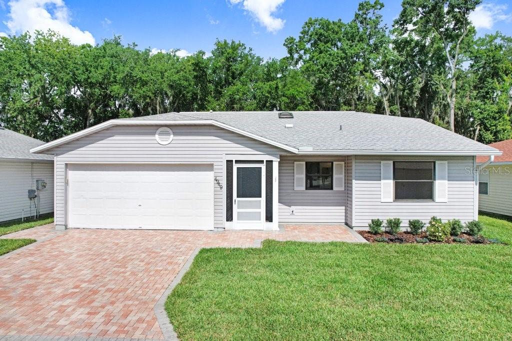 Virtually Staged. Newly Renovated, Bright, and Open~ This Delightful Home is located in the gated, golf cart friendly, 55+ Colonnades community. New Luxury Vinyl Plank Flooring, new Light Fixtures, new bathroom Vanities and Mirrors, new Outlet and Light Switch Plates, updated Door Hardware and a layout that flows beautifully are just a few highlights. Newly Painted Interior walls and ceilings (No Popcorn!), trim and doors enhance the home. Even the spacious two-car garage ~ with sink and storage ~and the teal colored front door have fresh coat of paint.  Step into the foyer where Vaulted Ceilings and a Skylight illuminate the expansive living and dining area. 
To the right of the foyer, a hallway leads to two generously sized bedrooms featuring ample natural light and large Walk-in Closets. Foyer and Hall closets provide additional storage. The hall bathroom has a tub/ shower, linen closet and a Jack-and-Jill design, giving access to guests and the private second bedroom. The primary suite, located to the left of the hall, features an en-suite bathroom with a step in shower, a new toilet in its separate area, and access to the walk-in closet. The well-appointed kitchen and dinette, illuminated by new light fixtures and large windows, feature new cabinet hinges and pulls, stainless steel appliances, and pantry. Two sets of sliding glass doors, from the dinette and the living room, open to an enclosed rear patio and adjacent outdoor terrace. 
The updated interiors are truly complimented by the charming curb appeal!  Pavers adorn the driveway, the home’s entrance, and the rear terrace. New landscaping and new irrigation help keep the grounds thriving. Large trees tucked behind the neighboring rear fence makes the patio and terrace perfect venues to enjoy the serenity nature brings. This desirable residence is situated in a community offering abundant green spaces, fishing pond with dock, a clubhouse, gym, large swimming pool, and more. Low monthly HOA fee include access to these amenities, plus cable, internet, lawn mowing and edging. Whether you are looking for a vibrant or relaxed lifestyle, the Colonnades provides you lots of options. Enjoy a tour of this lovely home and explore the possibilities ~ you just might choose to stay!