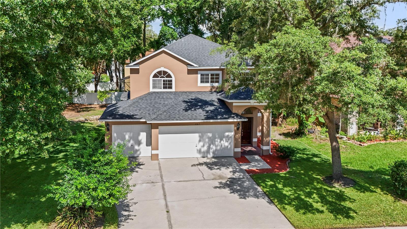 Welcome to Prairie Lakes, an established community just outside of Orlando where mature landscaping, spacious homes, and peaceful streets create a refreshing escape from the hustle and bustle. This home feels a bit like a midsummer “mountain spring”, bright, airy and a welcome retreat from the Florida heat! A classic brick front porch, three-car garage, and 2 story stature gives this home a traditional feel mixed with Florida. Solid panel, double entry doors give privacy with a 6 ft arched transom filling the entry with natural light. Inside, the open staircase has real wood treads creating an inviting first impression, while soaring ceilings and an abundance of windows allow sunshine to pour into nearly every room. Designed with both entertaining and everyday living in mind, the first floor offers formal living and dining rooms, a spacious family room, a functional kitchen, an indoor laundry room with a utility sink, and a convenient half bath for guests. A beautiful two-sided gas fireplace serves as the centerpiece between the formal living room and family room, adding warmth and character whether you’re hosting the holidays or enjoying a quiet evening at home. Tile and wood laminate flooring flow throughout the main living areas, making the home both stylish and easy to maintain. The home has also just been painted inside & out! Upstairs, you’ll find all of the bedrooms, including a comfortable primary suite featuring dual vanities, a relaxing soaking tub, a separate shower, and plenty of space to recharge at the end of the day. Three additional bedrooms share a full bath with adequate storage and a centrally located loft area. Out back, a paver patio is ready for summer cookouts, morning coffee, or evenings under the stars. The generously sized backyard offers plenty of room to design your dream outdoor oasis, whether that’s a sparkling pool, cozy fire pit, lush garden, or all of the above. Living here, you’re close to the famous attractions many wait their entire lives to visit once! Enjoy never ending places to go shopping & amazing restaurants; more importantly, easier access to world class healthcare, job opportunities and a ton of educational choices!