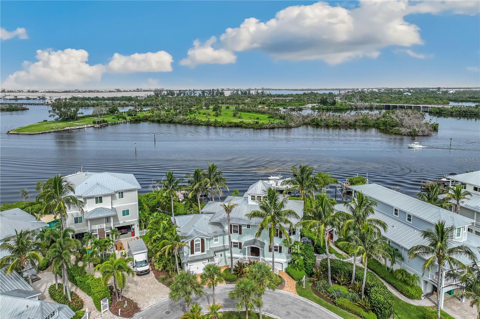 Experience exceptional waterfront living in this Coral Creek Anglers Club residence by Safety Harbor Builders, offering 3,886 sq ft with 4 bedrooms and 4.5 baths. The entry level features a spacious family/media room, two guest suites with en-suite baths, and a charming bunk cubby, plus expanded private guest accommodations above the garage.
The main living level includes elegant living and dining areas, a recently updated kitchen, and a luxurious primary suite. Custom details throughout include granite and quartzite countertops, wood floors, crown moldings, and beadboard accents.
Waterside decks and porches on every level provide stunning views and sunset enjoyment, while the top-floor office offers panoramic water vistas. Outdoors, a deepwater dock with 16,000 lb. and 8,000 lb. boat lifts delivers outstanding boating access. Located in a gated community with pool and clubhouse, and close to bike trails, fishing, and nearby islands. Sold tastefully furnished and move-in ready.