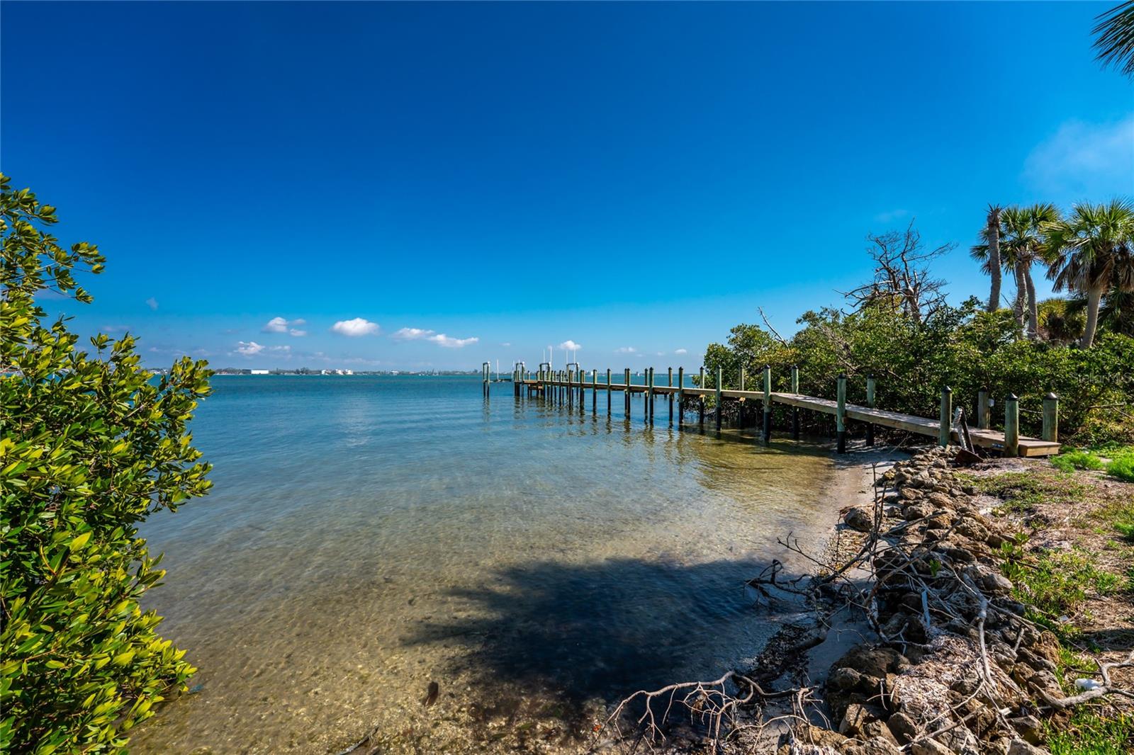 Build your dream coastal home on this rare cleared BAYFRONT lot on Manasota Key! Located at 4025 Bay Oaks Circle, this oversized property offers a private dock with two  boat lift , one is 10,000 lbs and second 7,000 lbs (installed 2016) and direct access to Lemon Bay and the Intracoastal Waterway. The previous home was professionally demolished, and the lot is cleared and ready to build with city water and sewer already connected. Electricity is available at the site but not currently connected.

Situated in a small, quiet circular community with a private road, owners also enjoy access to a community bayfront area, boat ramp, and dock. A deeded Gulf beach access is located directly across the street—just steps to white sand and turquoise water. This exceptional location provides the perfect blend of bayfront boating and Gulf beach living while being only minutes to Englewood Beach, restaurants, marinas, and shopping.

A rare opportunity to build on Manasota Key with both bay access and deeded beach access. Bring your architect and create the Florida coastal home you’ve always imagined.