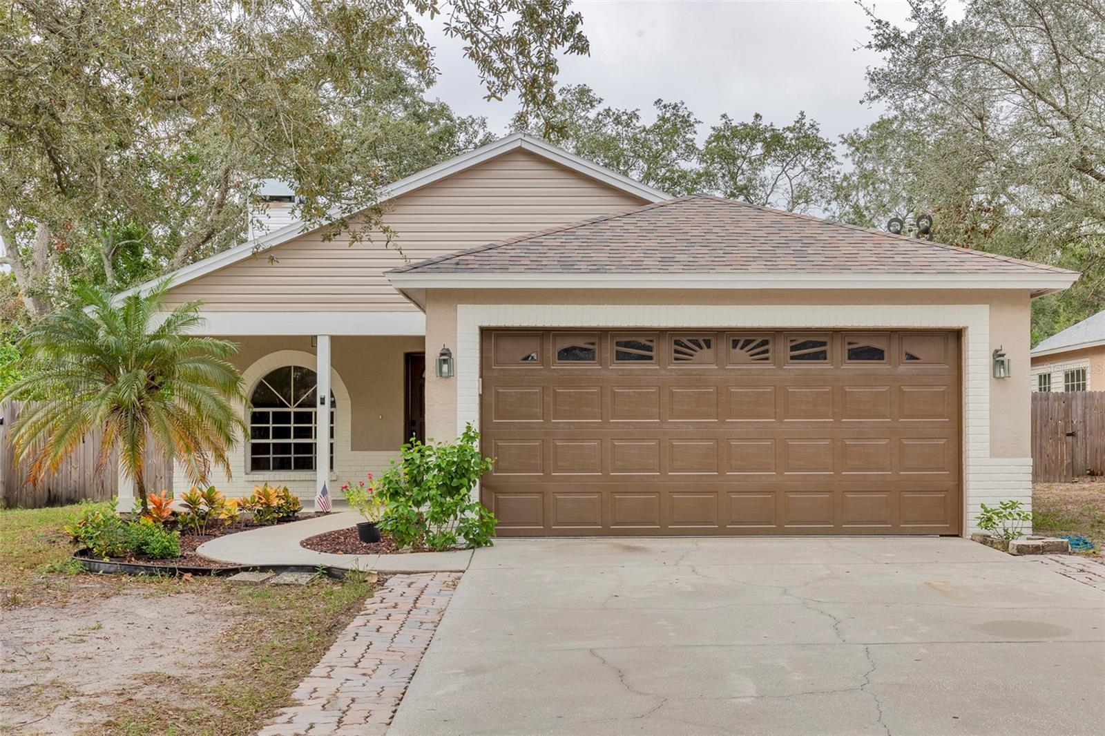 Welcome to this beautifully remodeled three-bedroom, two-bathroom home nestled in an idea location near the scenic Pinellas Trail. This charming property seamlessly blends some modern comforts with timeless appeal, offering a perfect retreat for those seeking both style and tranquility. Upon entering, you'll be greeted by a warm and inviting living space highlighted by a cozy fireplace, creating a perfect focal point for gatherings or quiet evenings. The open-concept design seamlessly connects the living area to a spacious kitchen with an over-sized island perfect for family gatherings, making it a chef's delight. The three bedrooms are thoughtfully designed to provide both comfort and functionality. The master suite boasts a private oasis, complete with an ensuite bathroom for added convenience. The additional bedrooms are versatile spaces that can be tailored to suit your unique needs, whether it be a home office, guest room, or hobby space. ROOF 2013 A/C UNIT 2011
Step outside and discover a lush oasis of greenery. The property features a variety of fruit and herb trees, providing a delightful and sustainable touch to your outdoor space. Enjoy cooking a meal under your outdoor pergola. Imagine enjoying fresh herbs and fruits from your own garden, creating a true farm-to-table experience right at home. The location of this residence is truly unbeatable for outdoor enthusiasts. The renowned Pinellas Trail is just a stone's throw away, offering miles of scenic pathways for walking, jogging, or cycling. Embrace an active lifestyle surrounded by nature and the beauty of the Florida landscape. In summary, this remodeled three-bedroom, two-bathroom home is a haven of comfort, style, and outdoor bliss. From the beautifully remodeled interior to the bountiful garden and proximity to the Pinellas Trail, every detail has been carefully curated to provide an exceptional living experience. This home is located within only a few minutes from the Tarpon Springs Sponge Docks, Wall Springs Park, A. L. Anderson Park, hospital, pharmacy, shopping and much more. Don't miss the opportunity to make this property your own and start enjoying the best of Florida living. Call Jan now for your private showing and start packing!