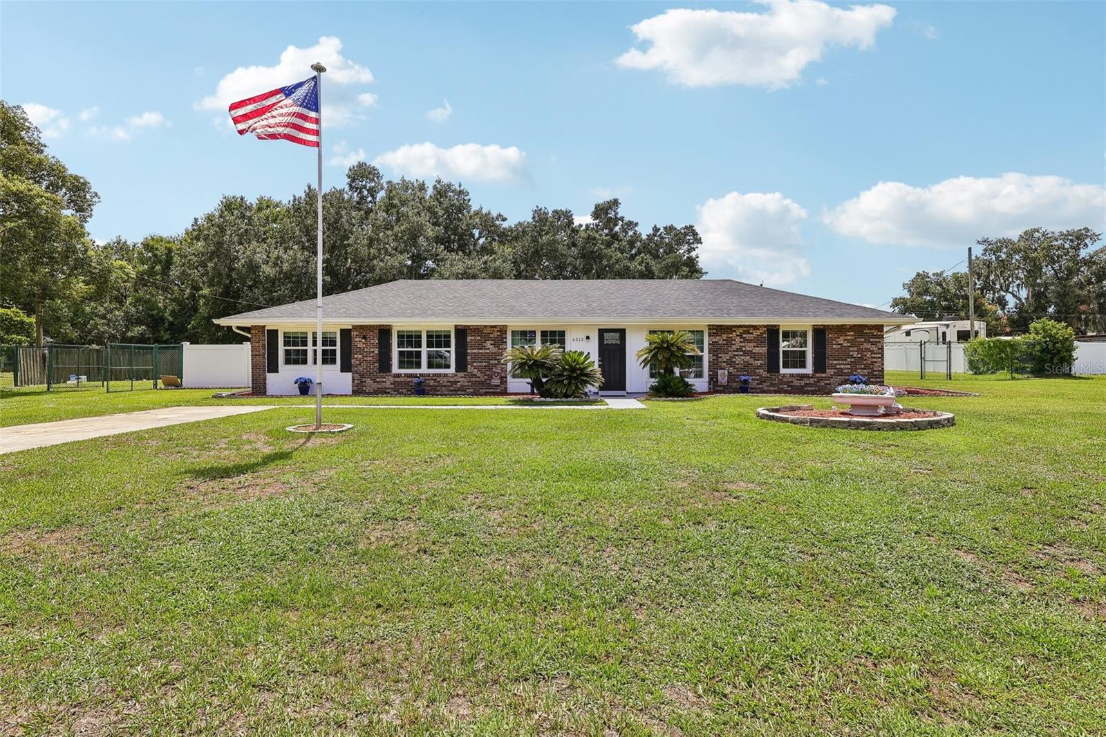 Welcome to your own private retreat in South Lakeland, where comfort, functionality, and outdoor living come together on an expansive **0.67-acre** fully fenced homesite. This well-maintained **3-bedroom, 2-bathroom** home offers **1,584 square feet** of thoughtfully designed living space with updates that provide peace of mind for years to come. **NO HOA**

Inside, you'll find a spacious living room and an updated kitchen featuring **granite countertops**, **stainless steel appliances**, an eat-in dining area, and bar seating—perfect for everyday living and entertaining alike. Brand-new **Pella windows (2026)** enhance energy efficiency while allowing natural light to fill the home.

The primary suite offers a private en-suite bathroom with a walk-in shower and single vanity. Two additional guest bedrooms are conveniently located near the guest bathroom, complete with dual sinks and a tub/shower combination.

Step outside and enjoy Florida living at its best. The screened pool enclosure overlooks a **14' x 28' chlorine pool** with a relaxing water feature, featuring a shallow entry on both ends and an approximate 6-foot deep center. The spacious screened lanai includes a **pool table that conveys**, creating the perfect space for entertaining family and friends.

The oversized backyard is fully fenced and includes a double gate for easy access to park an RV, boat, or additional vehicles beneath the covered parking area. A **30-amp RV electrical hookup** adds even more versatility. A **12' x 23' detached shed/workshop** with electricity, a roll-up door, and a side entry provides abundant storage or workspace for hobbies and projects. Plus, a covered parking area!

Additional highlights include:

* Roof replaced in 2023
* Water heater replaced in 2022
* A/C approximately 9 years old and professionally serviced twice annually
* County water services the home, with a separate irrigation well helping keep exterior water costs low
* Septic system with lift station and drainfield
* Average county water bill of approximately **$20/month**

Offering space, privacy, modern updates, and exceptional flexibility for RV owners, hobbyists, and those who love outdoor living, this property is a rare opportunity to enjoy the best of Central Florida living. Schedule your private showing today!